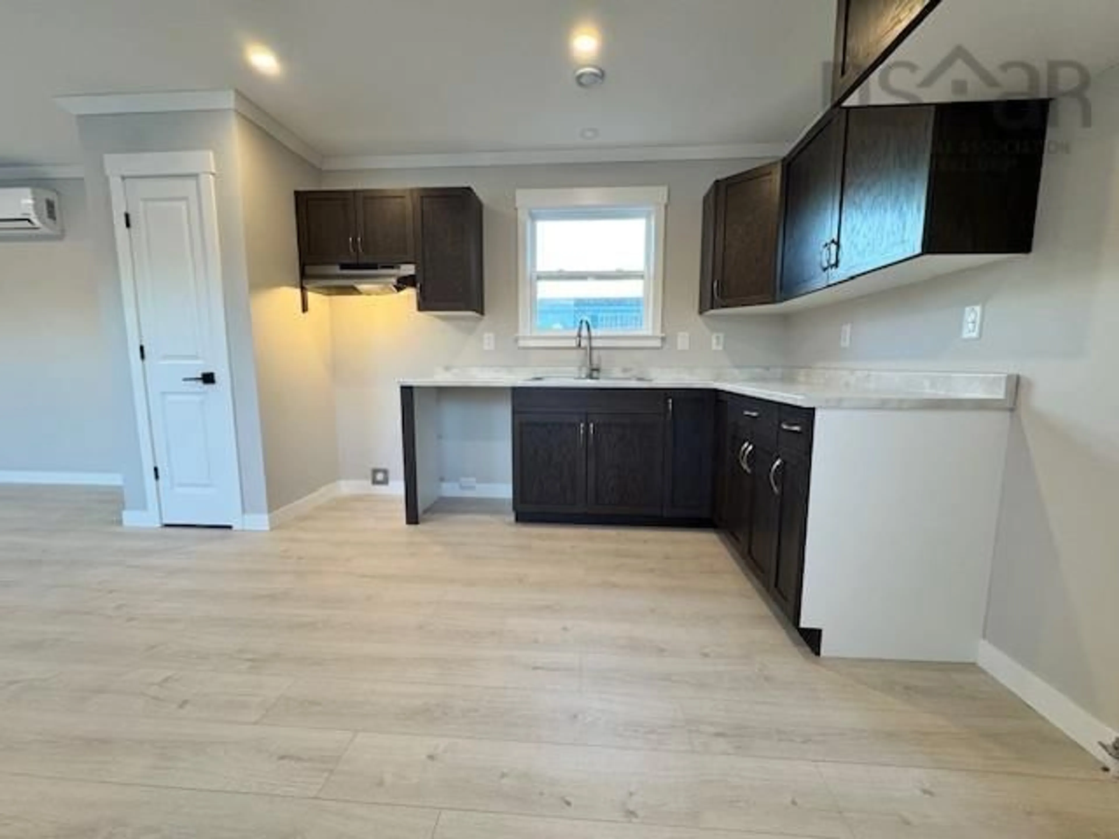 Open concept kitchen, wood/laminate floor for 18 Bruce St, Mount Uniacke Nova Scotia B0N 1Z0