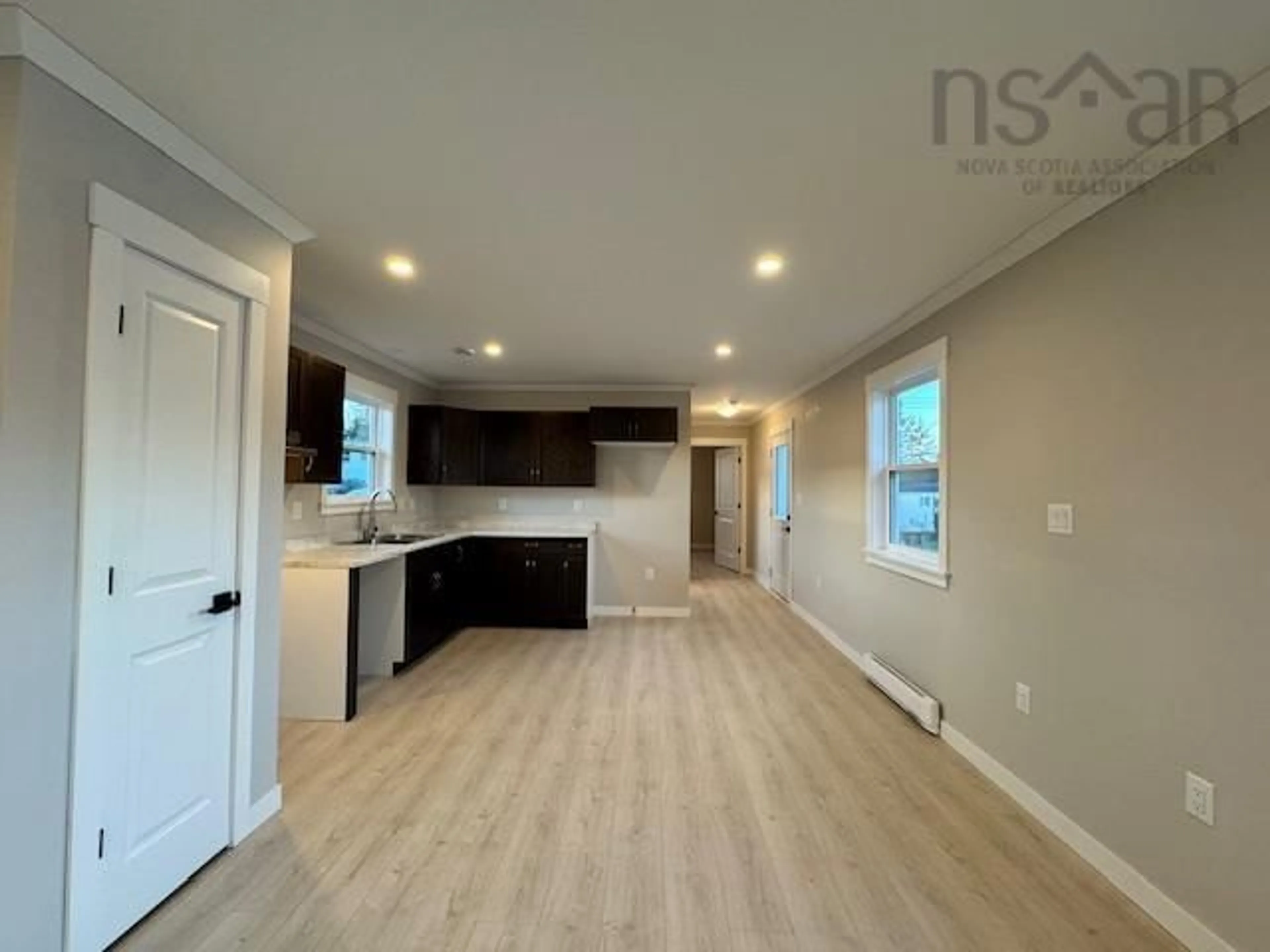 Open concept kitchen, wood/laminate floor for 18 Bruce St, Mount Uniacke Nova Scotia B0N 1Z0