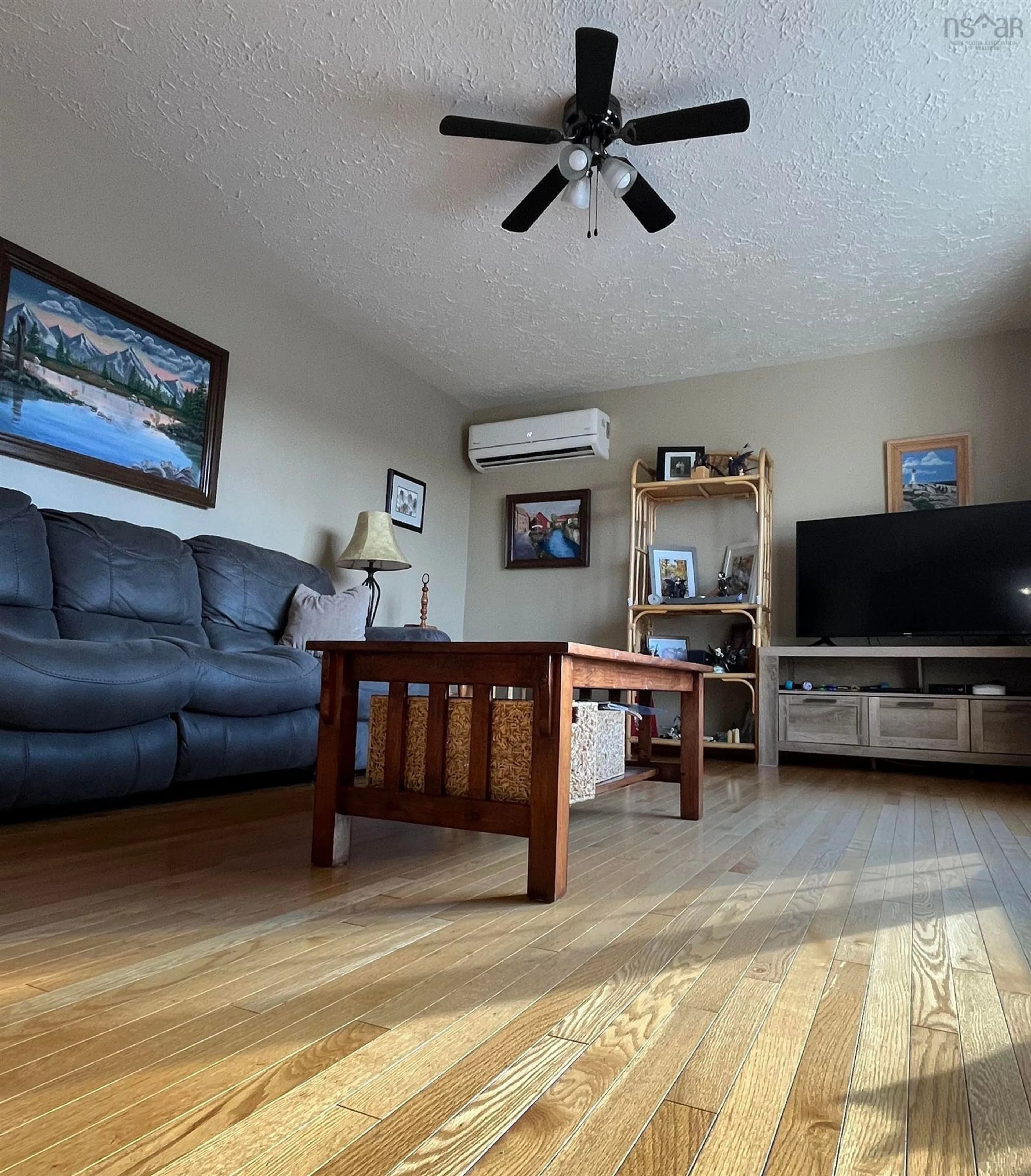Living room with furniture, wood/laminate floor for 1163 Maclellans Brook Rd, Stellarton Nova Scotia B2H 5C7