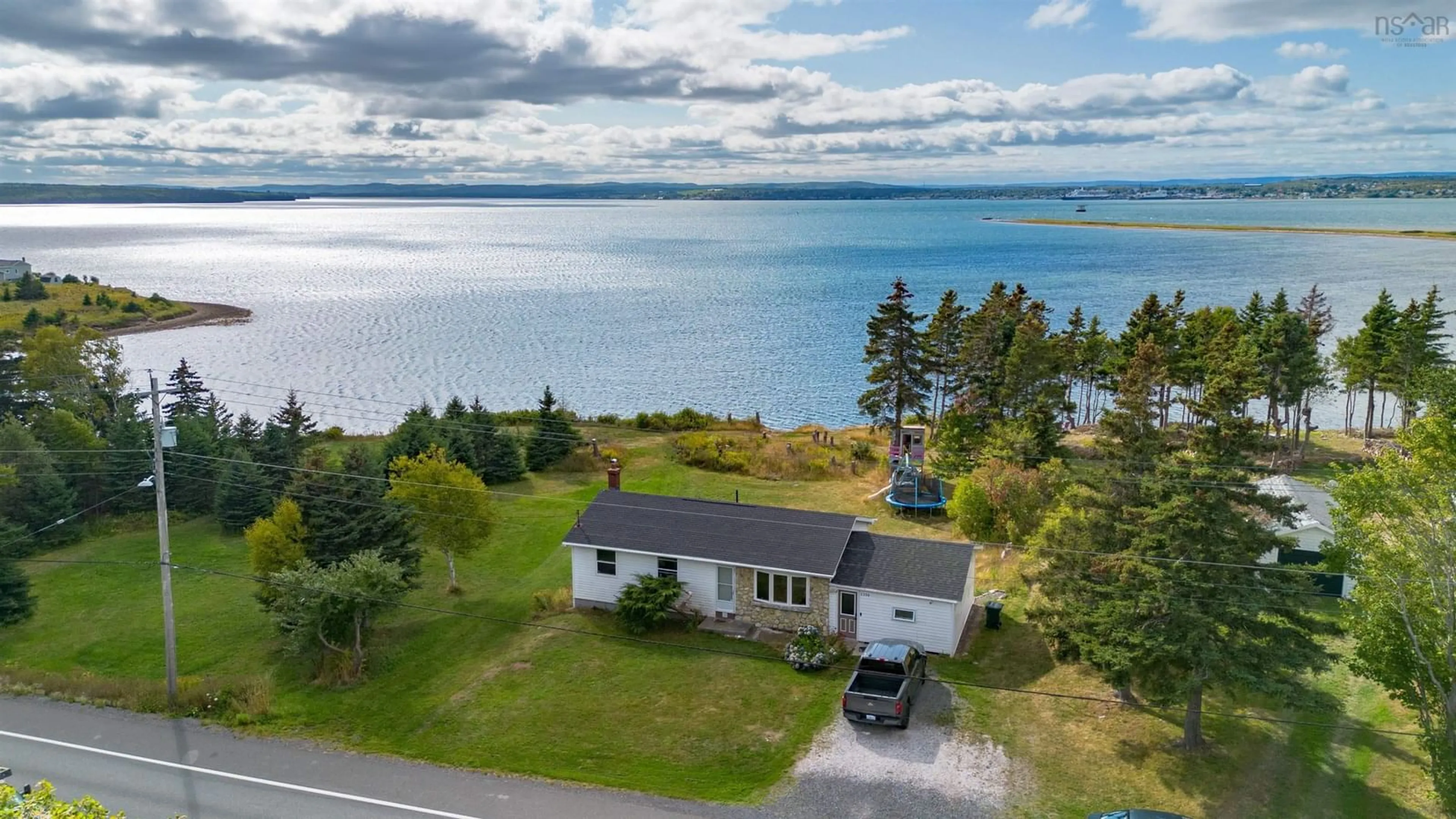 A pic from outside/outdoor area/front of a property/back of a property/a pic from drone, water/lake/river/ocean view for 2339 New Waterford Hwy, South Bar Nova Scotia B1N 3H9