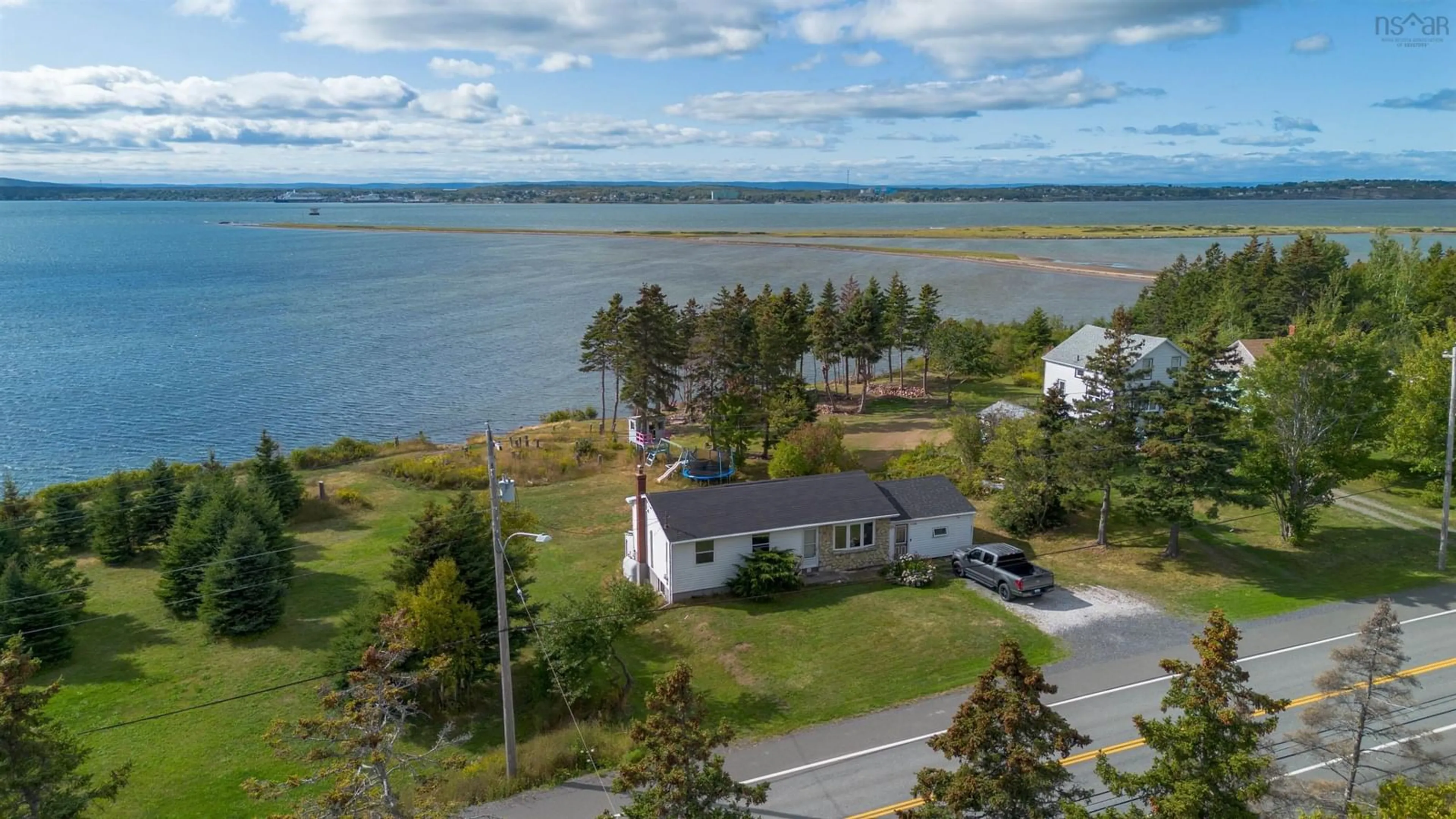 A pic from outside/outdoor area/front of a property/back of a property/a pic from drone, water/lake/river/ocean view for 2339 New Waterford Hwy, South Bar Nova Scotia B1N 3H9