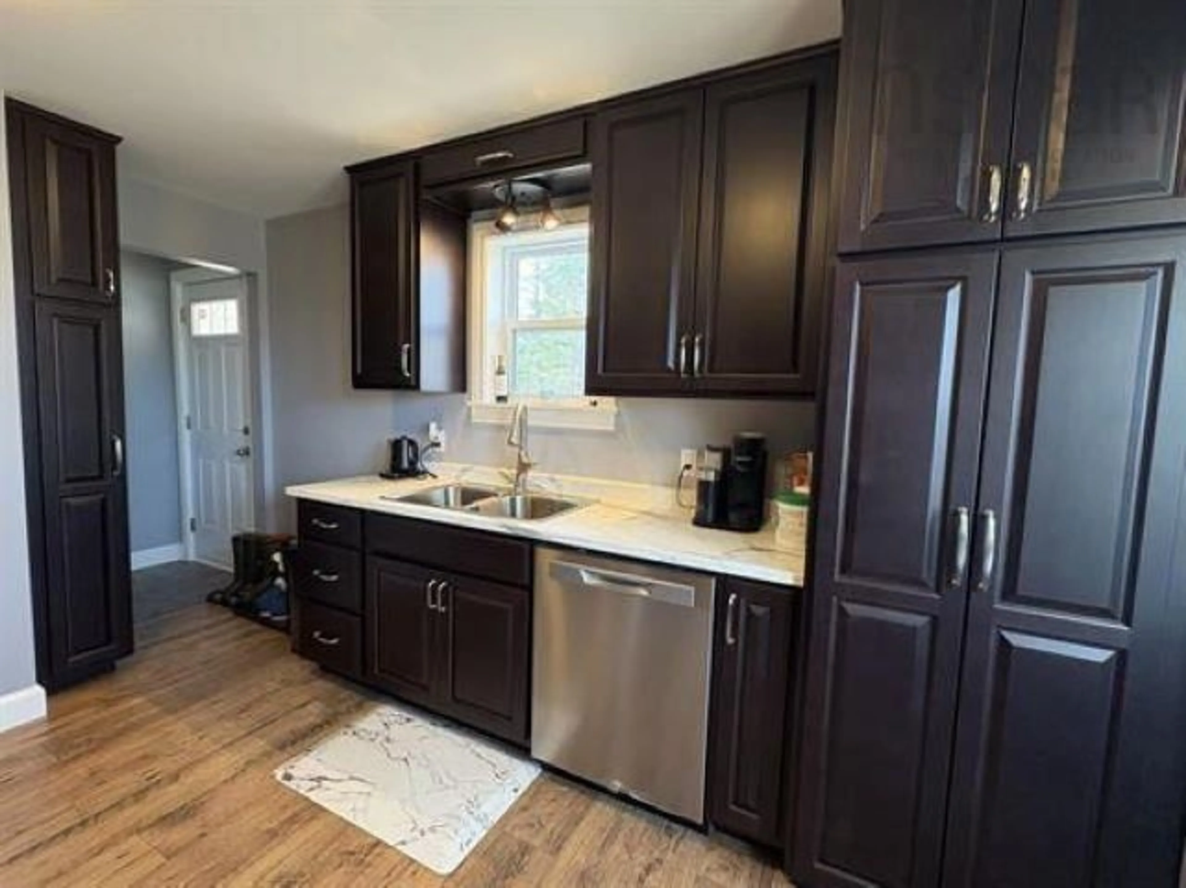 Open concept kitchen, wood/laminate floor for 21 Marconi St, Louisbourg Nova Scotia B1C 1K2