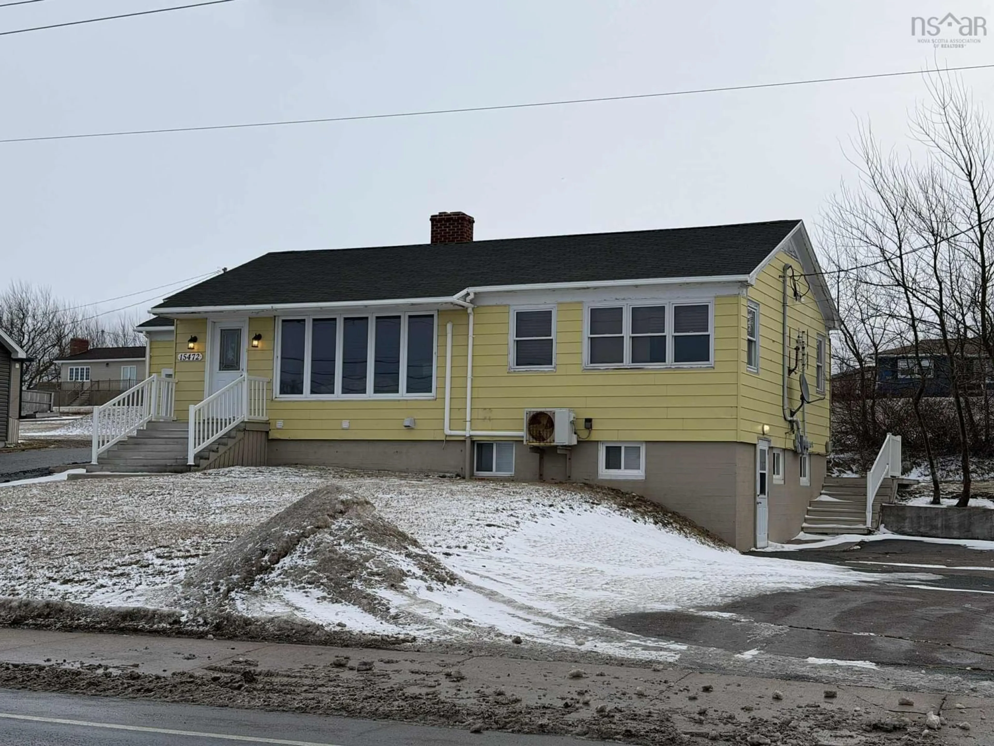 Home with vinyl exterior material, street for 15472 Cabot Trail, Chéticamp Nova Scotia B0E 1H0