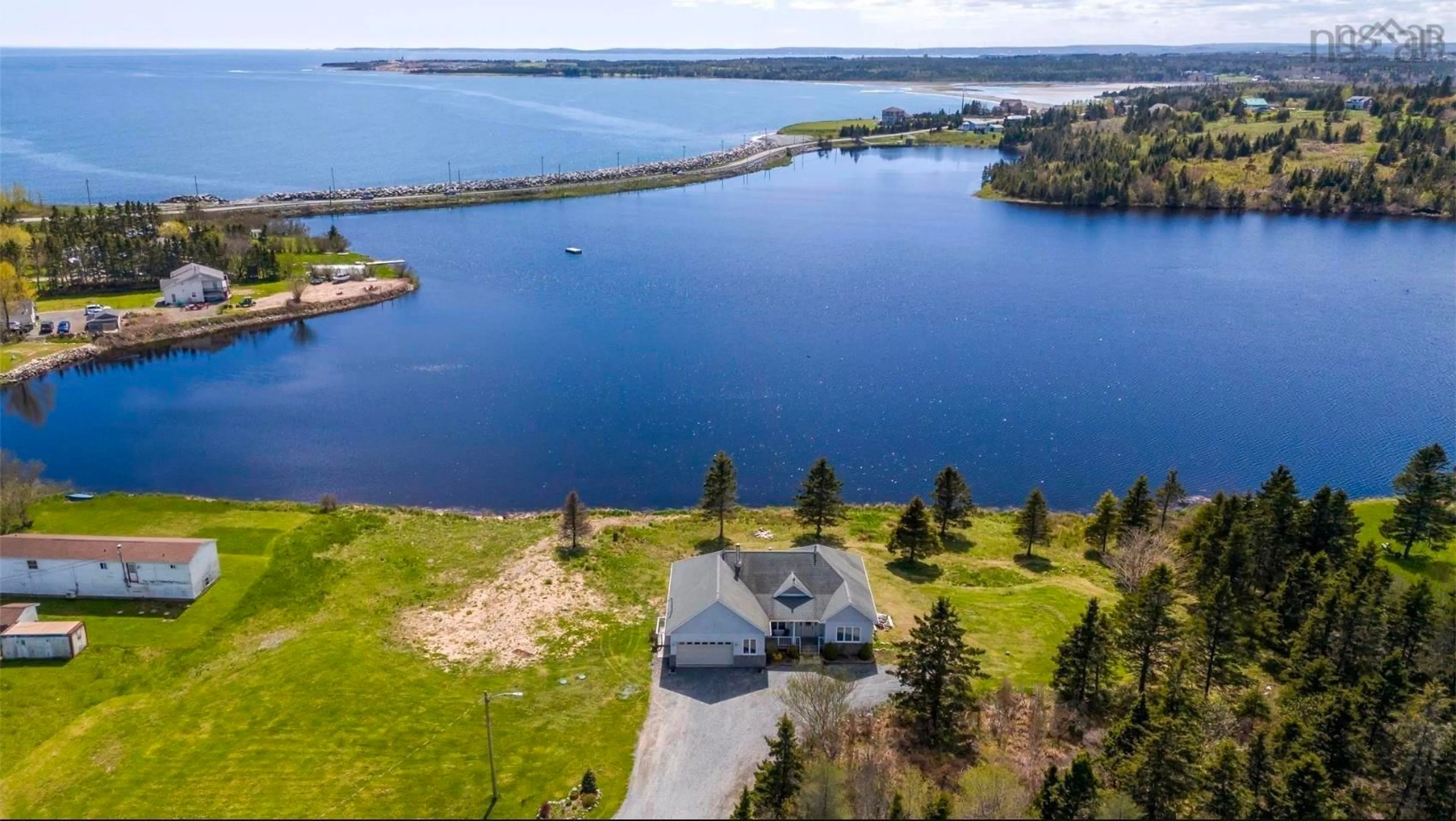 A pic from outside/outdoor area/front of a property/back of a property/a pic from drone, water/lake/river/ocean view for 1480 Cow Bay Rd, Cow Bay Nova Scotia B3G 1L3