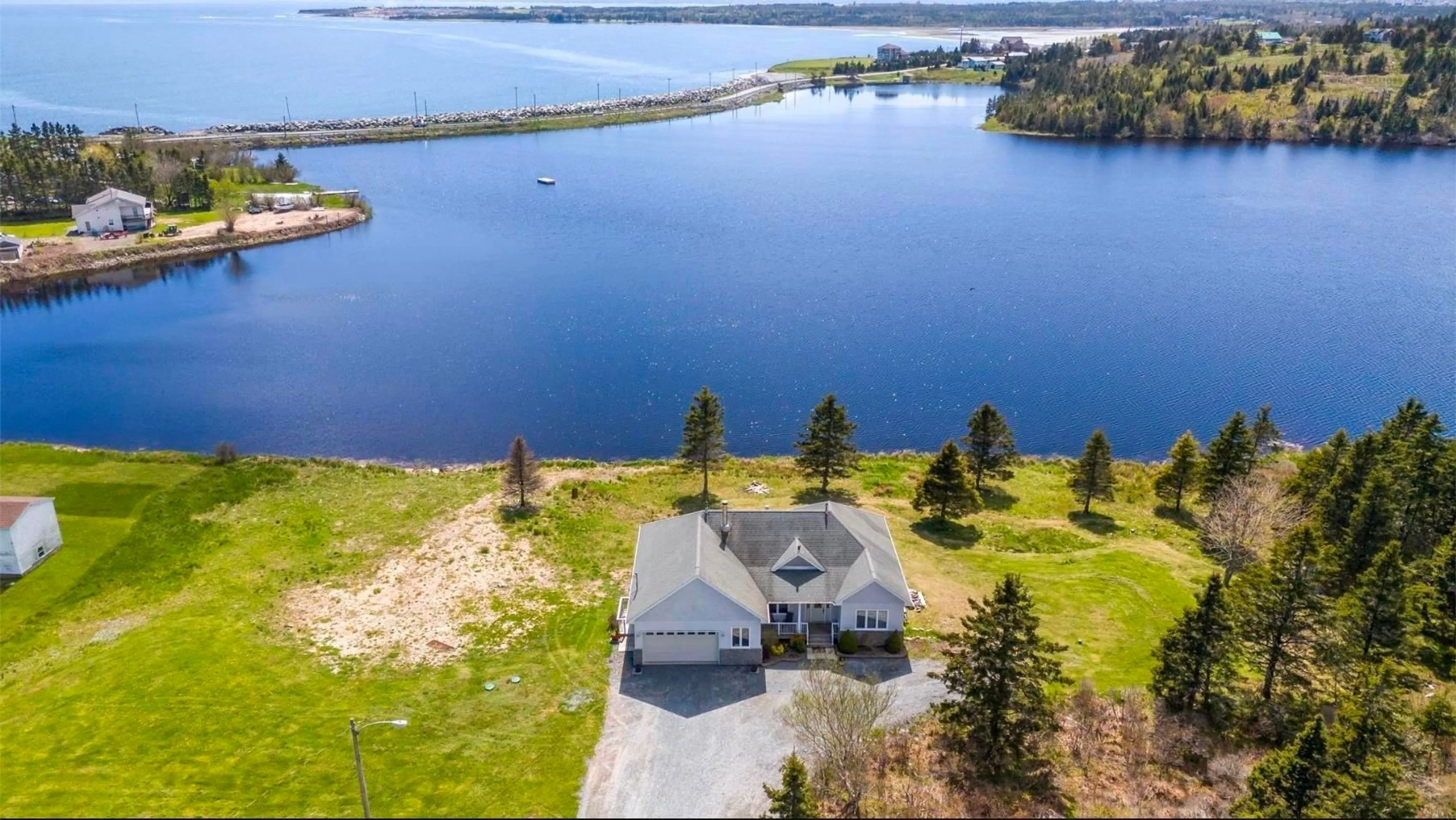 A pic from outside/outdoor area/front of a property/back of a property/a pic from drone, water/lake/river/ocean view for 1480 Cow Bay Rd, Cow Bay Nova Scotia B3G 1L3
