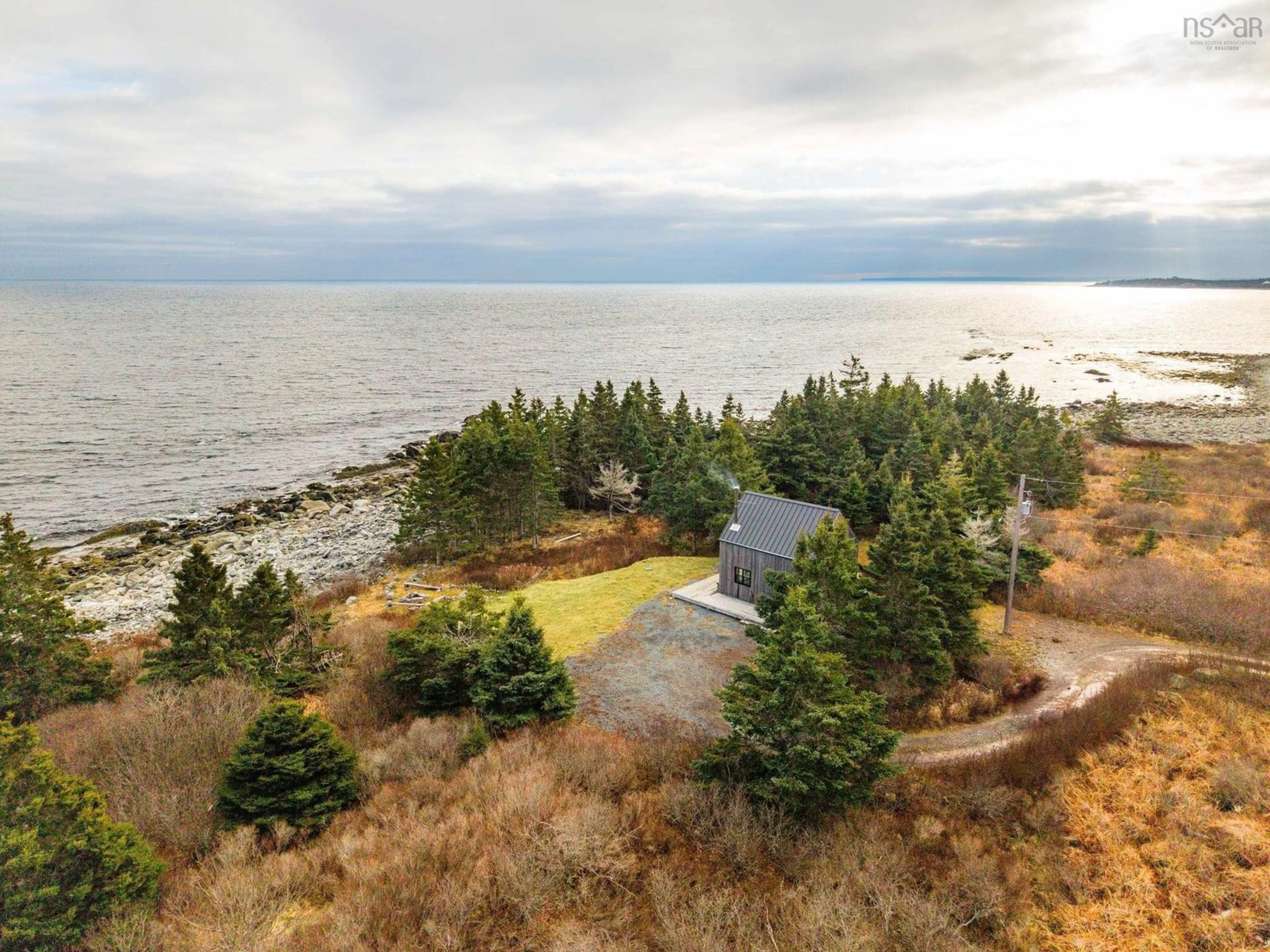 A pic from outside/outdoor area/front of a property/back of a property/a pic from drone, water/lake/river/ocean view for 77 Sand Beach Rd, Western Head Nova Scotia B0T 1K0