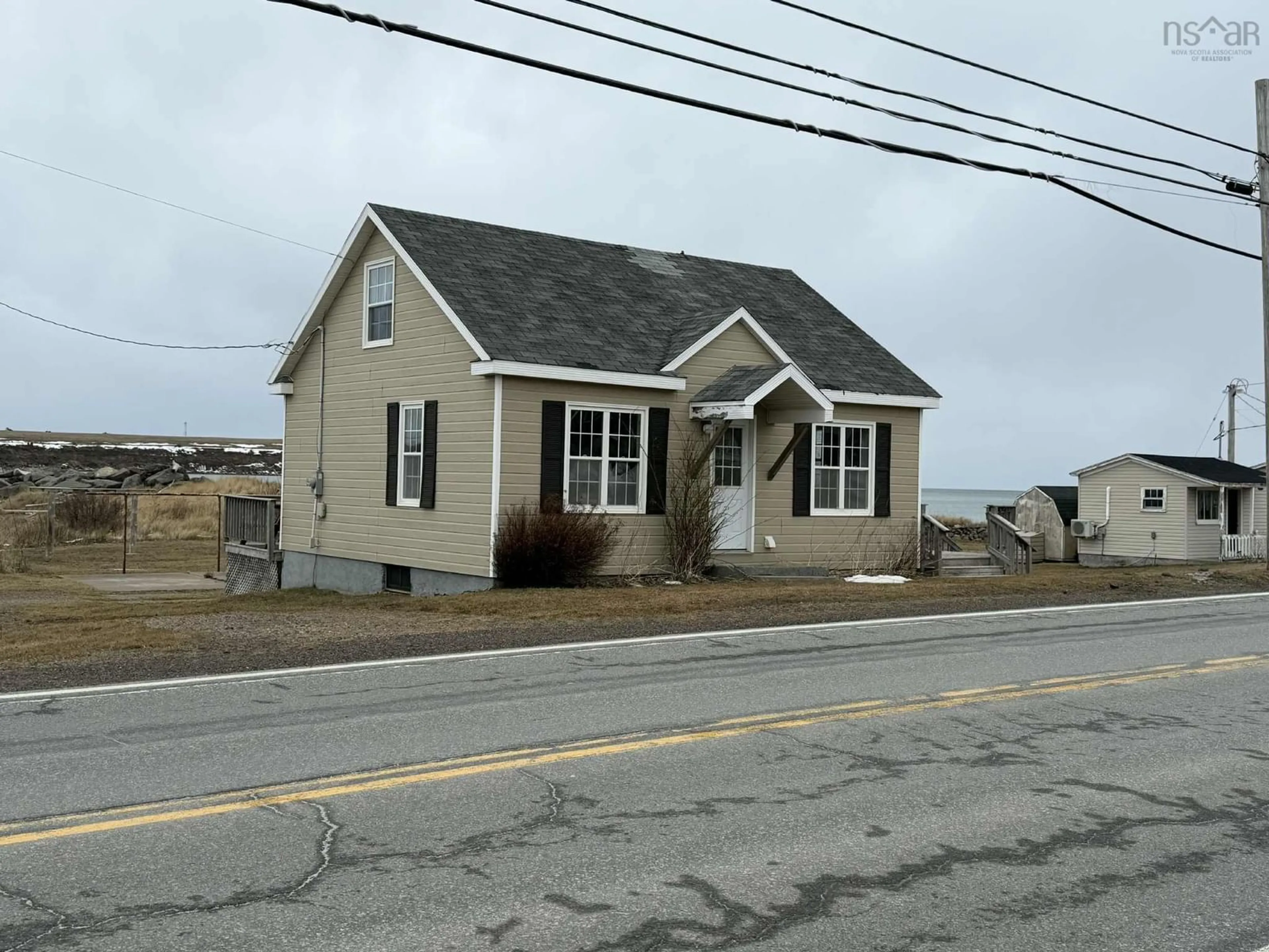 Home with vinyl exterior material, street for 15479 Cabot Trail, Chéticamp Nova Scotia B0E 1H0