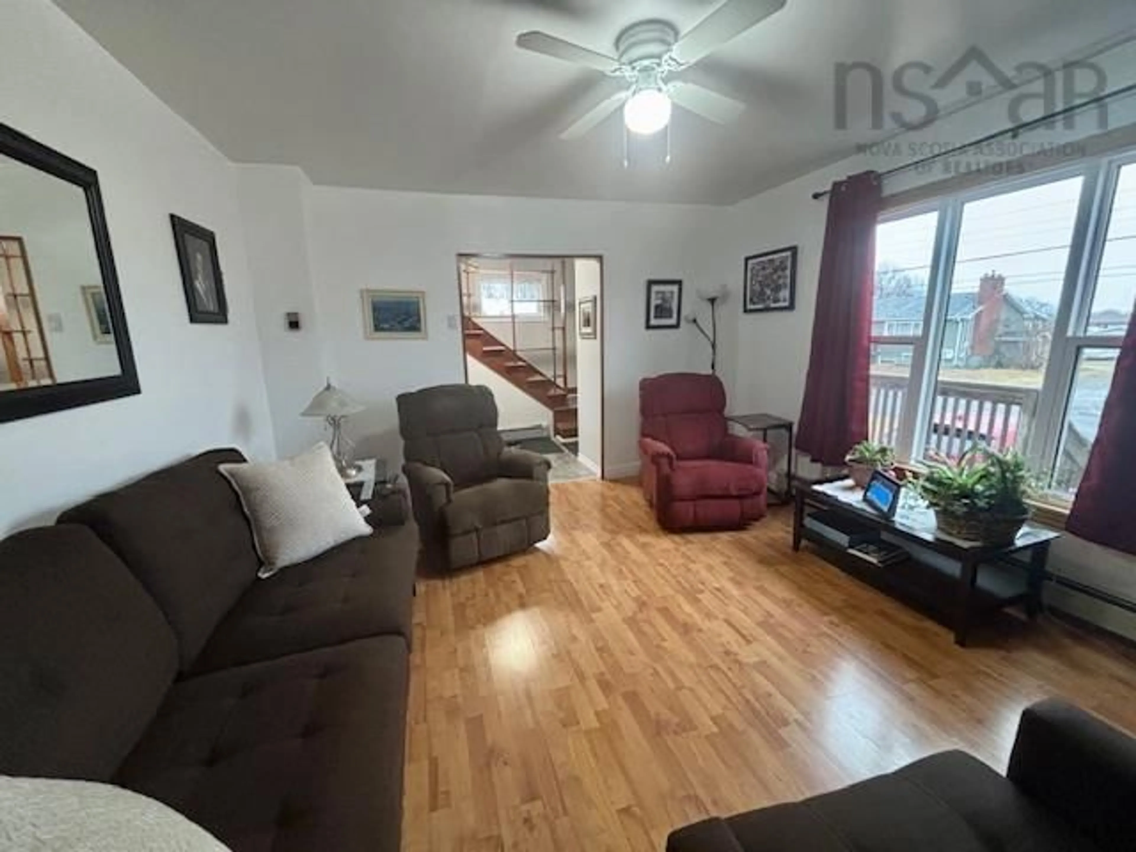 Living room with furniture, wood/laminate floor for 721 St. Joseph St, New Waterford Nova Scotia B1H 4G5