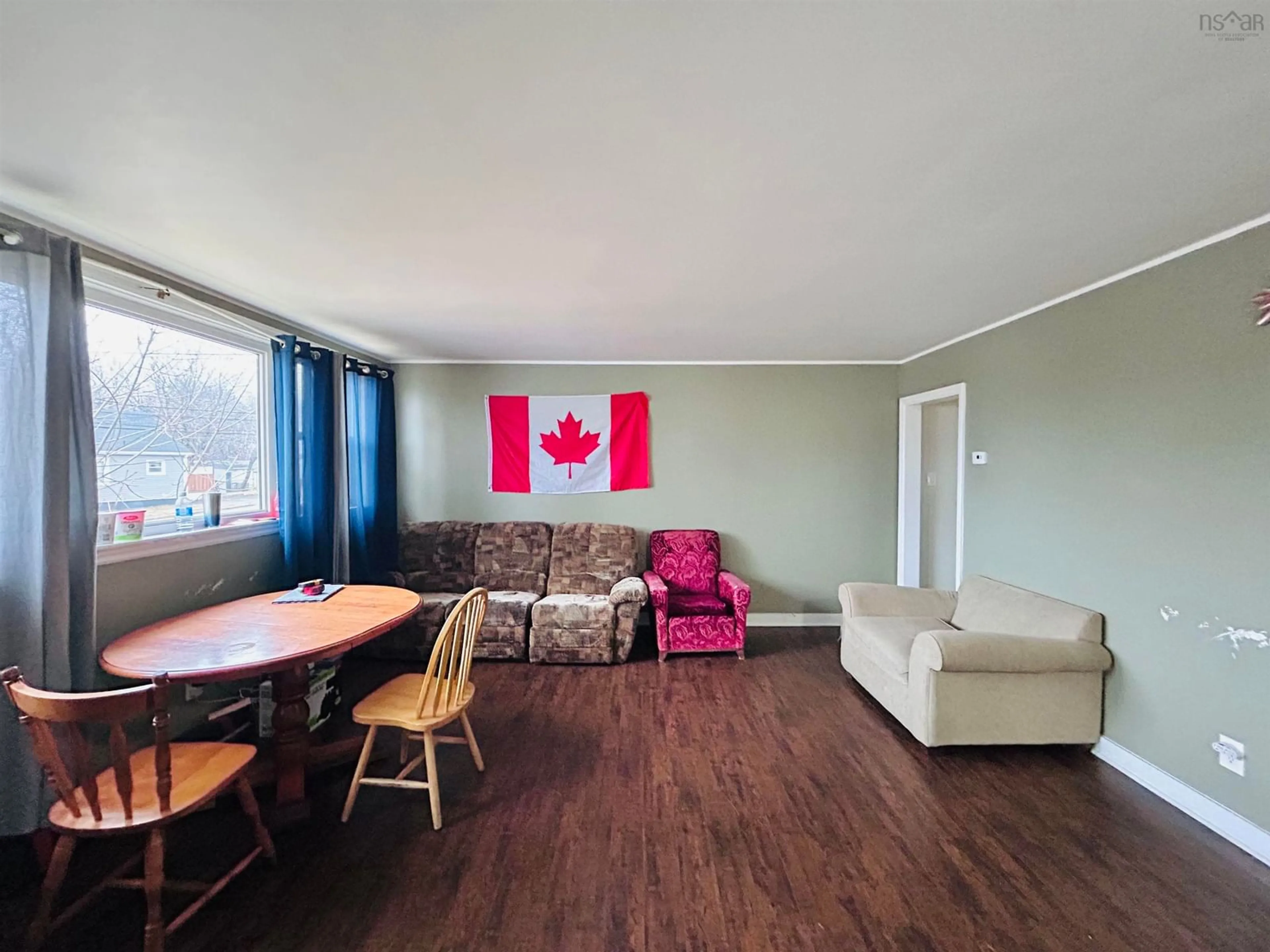 Living room with furniture, wood/laminate floor for 816 Upper Prince St, Sydney Nova Scotia B1P 5N7