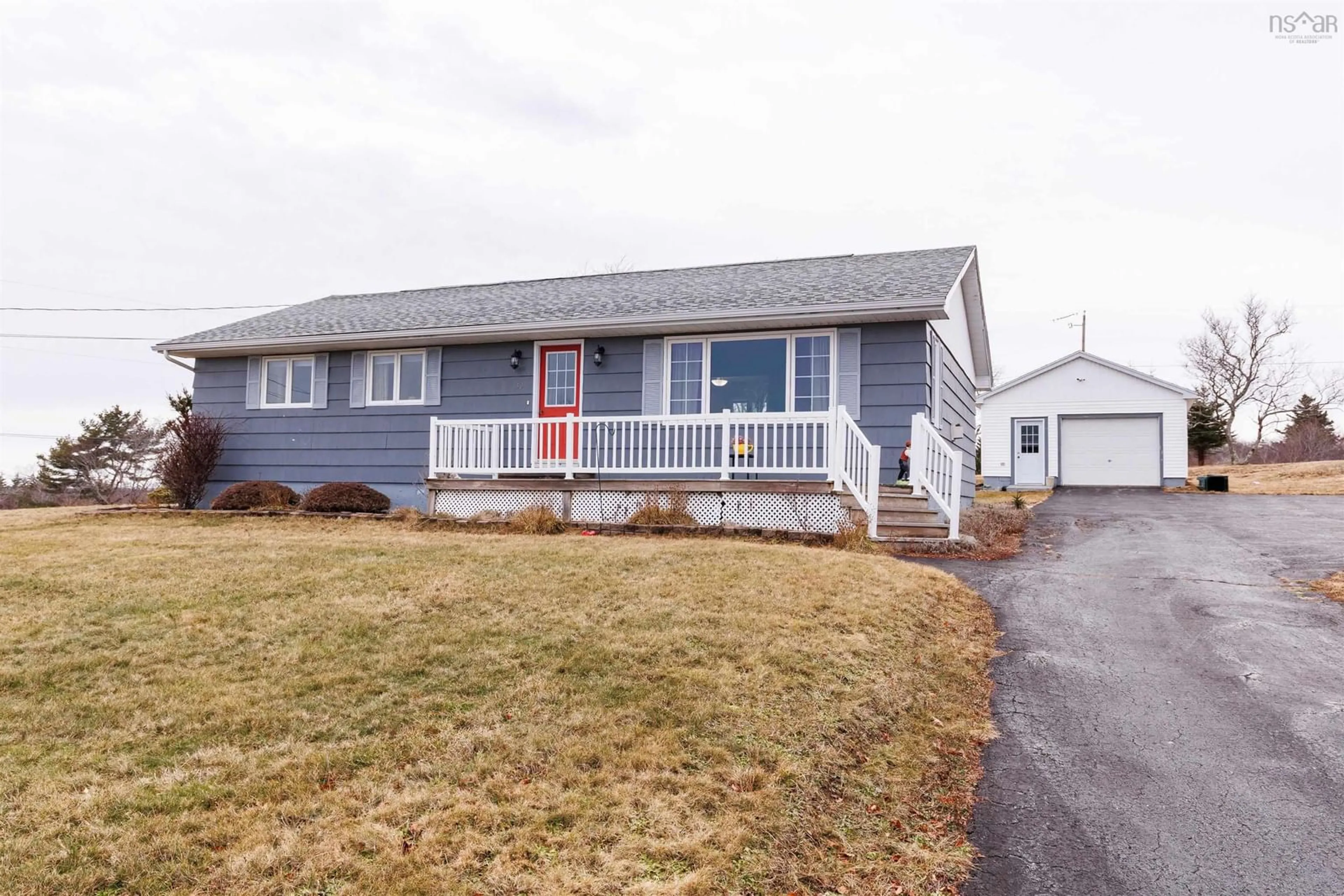 Home with vinyl exterior material, street for 32 Chemin Des Bourque, Ste. Anne Du Ruisseau Nova Scotia B0W 2X0