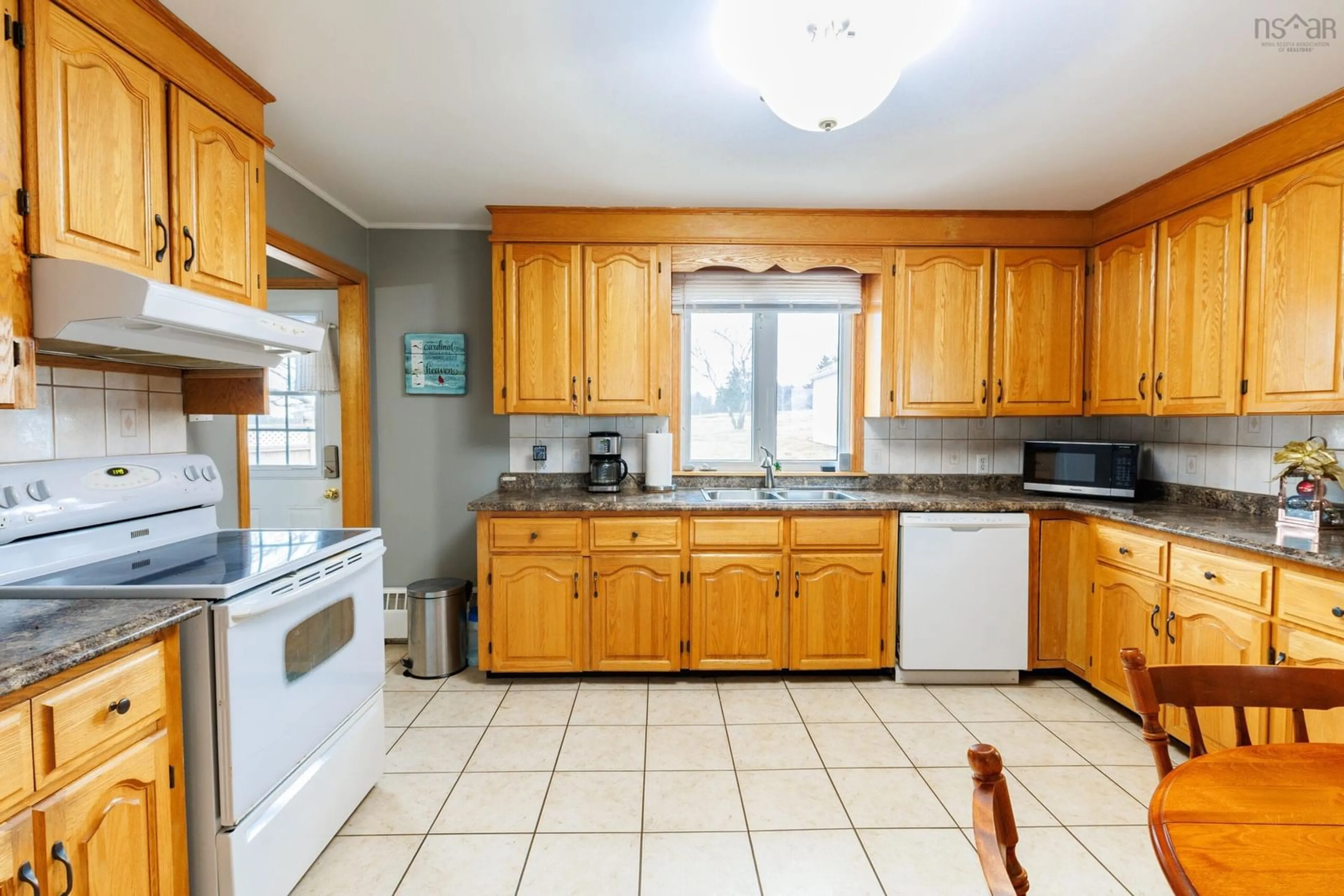 Standard kitchen, ceramic/tile floor for 32 Chemin Des Bourque, Ste. Anne Du Ruisseau Nova Scotia B0W 2X0
