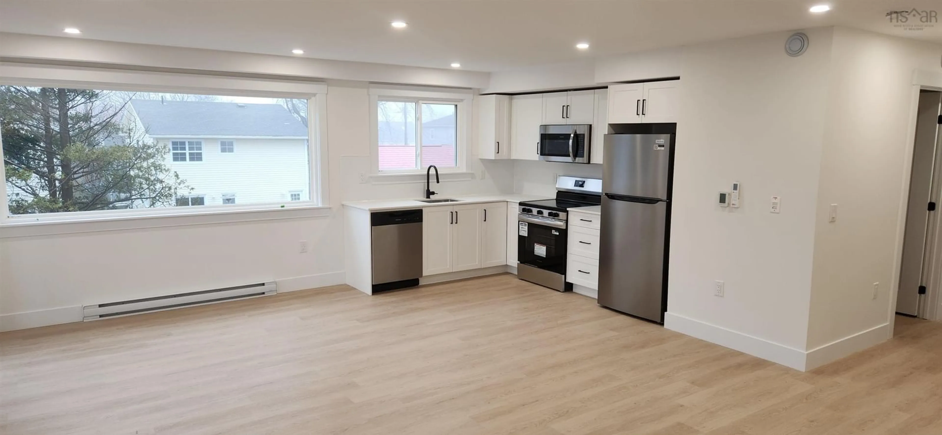 Open concept kitchen, wood/laminate floor for 3620 Highland Ave, Halifax Peninsula Nova Scotia B3K 4J7