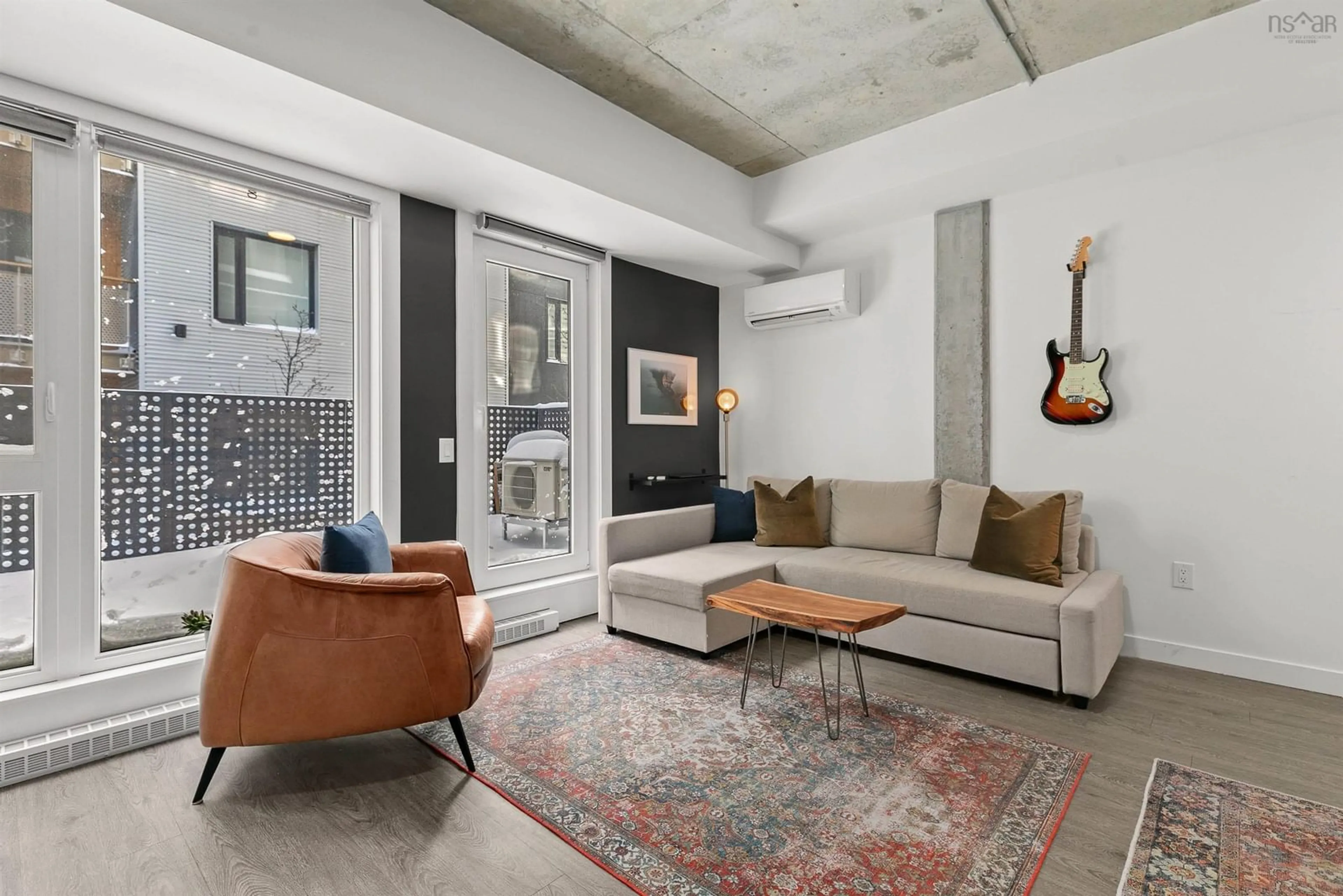 Living room with furniture, cement floor for 5684 West St #102, Halifax Nova Scotia B3K 1H7