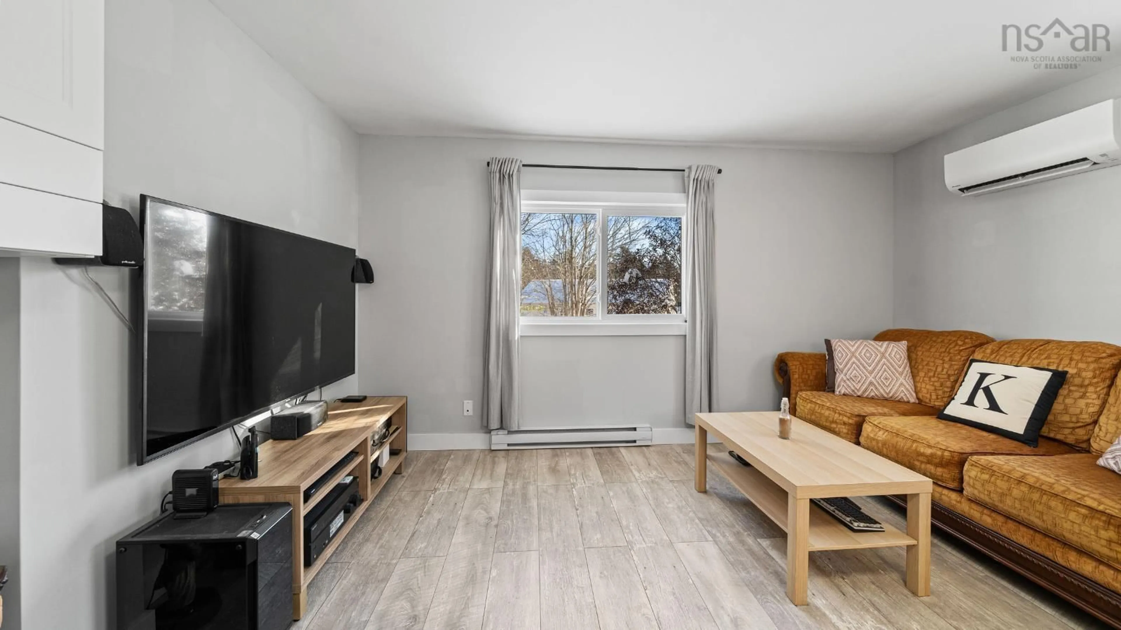 Living room with furniture, wood/laminate floor for 10 Sucker Brook Rd, Lower Sackville Nova Scotia B4C 4E7