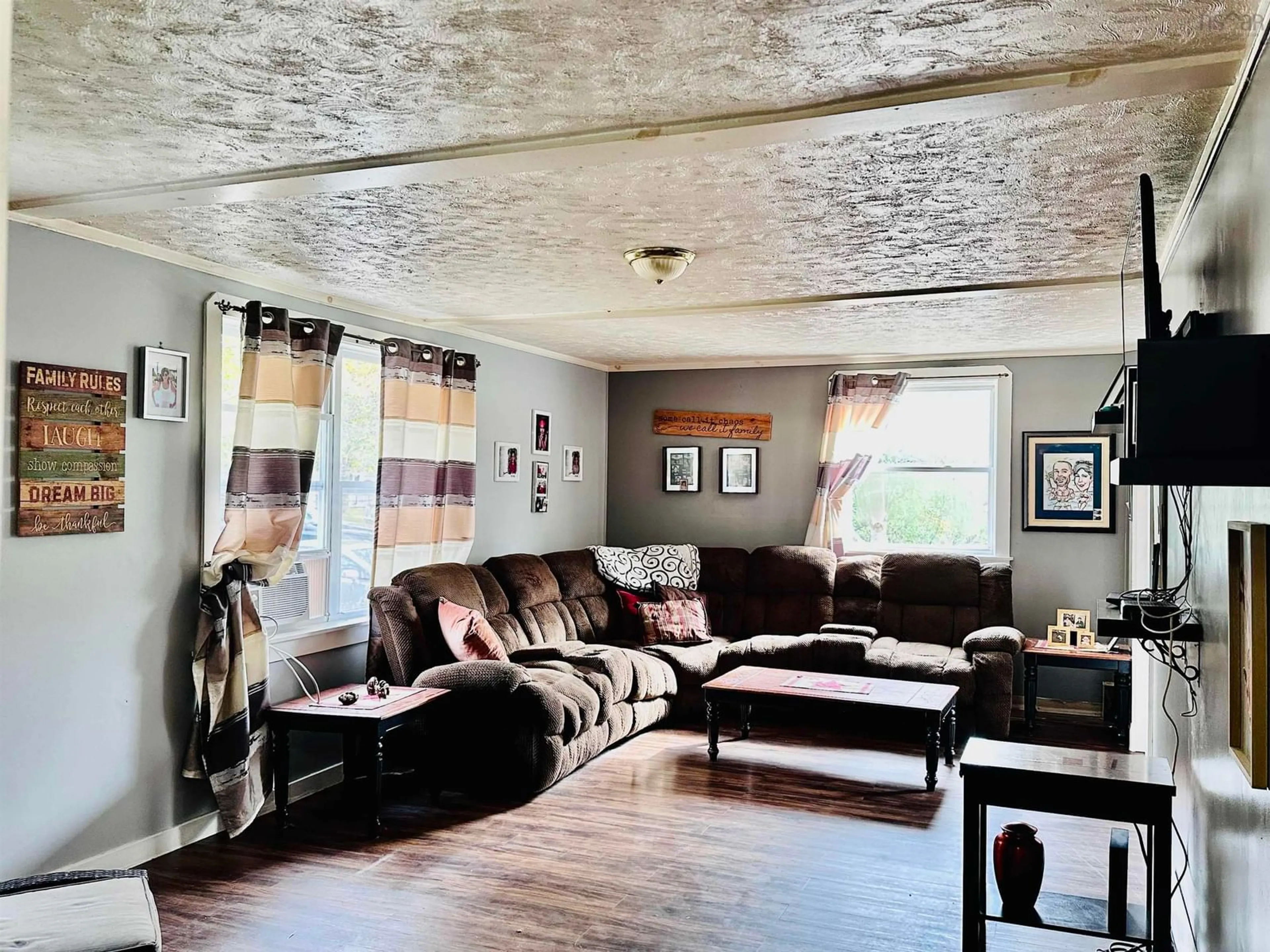 Living room with furniture, wood/laminate floor for 101 Parr St, Shelburne Nova Scotia B0T 1W0