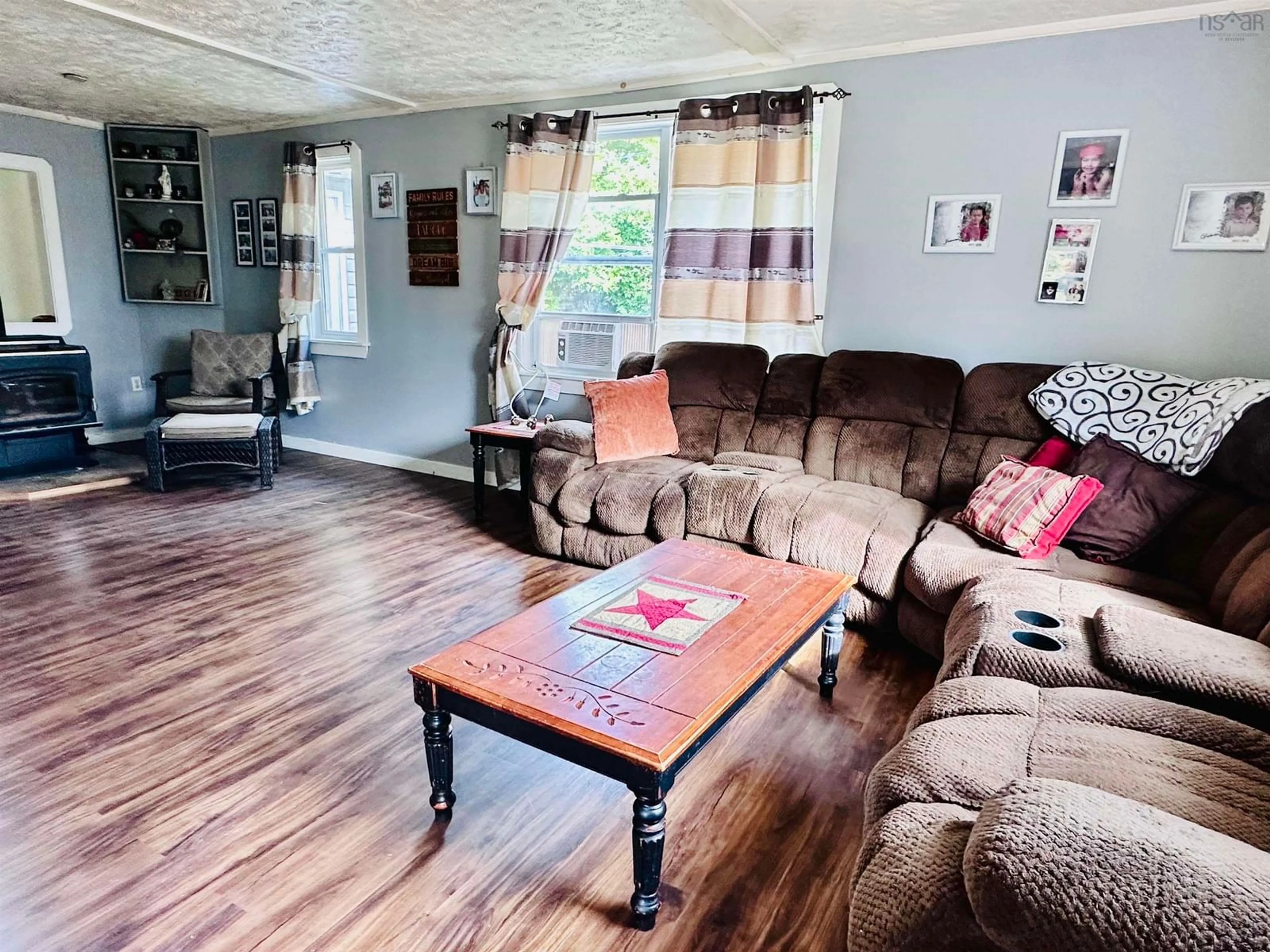 Living room with furniture, wood/laminate floor for 101 Parr St, Shelburne Nova Scotia B0T 1W0