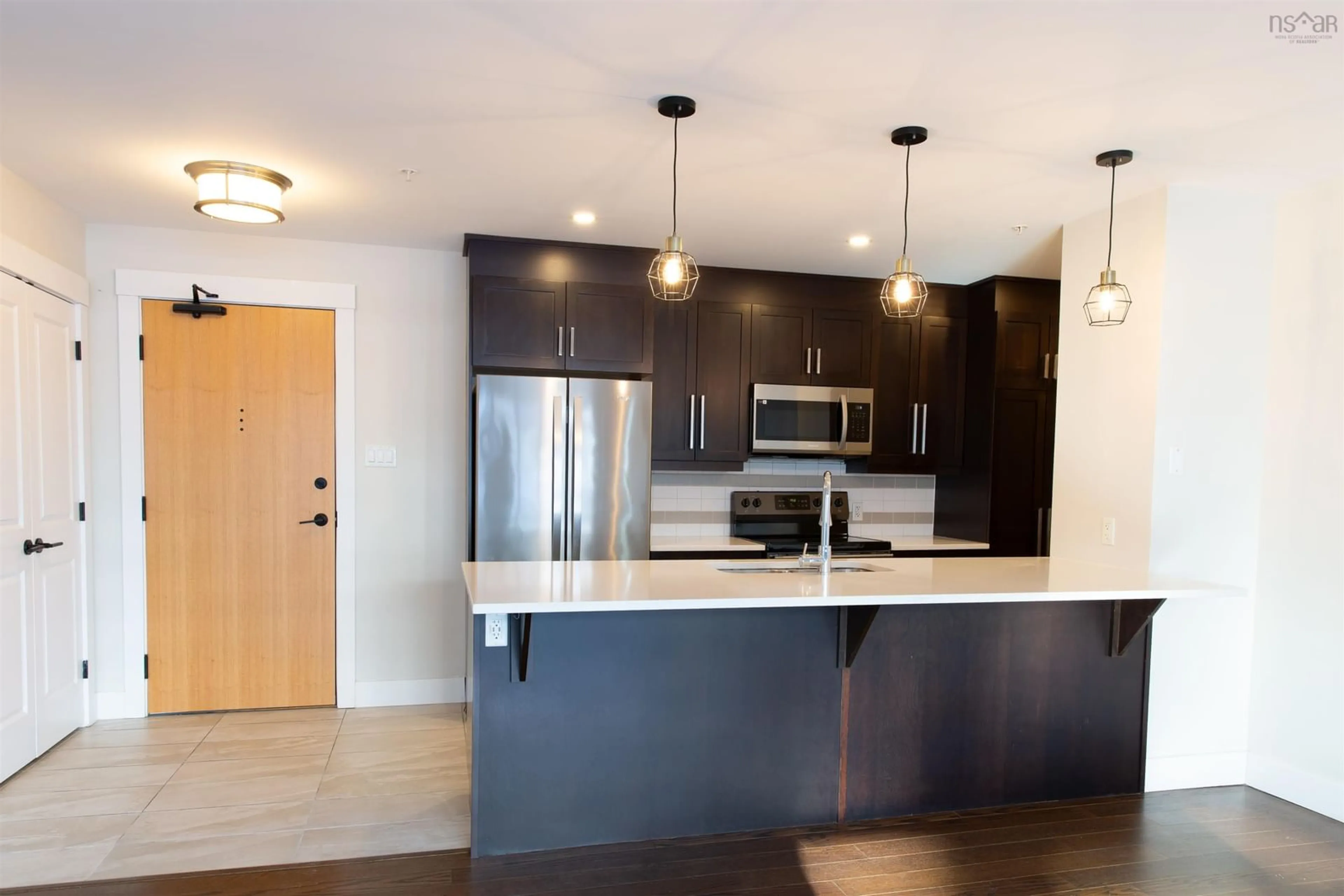 Open concept kitchen, wood/laminate floor for 1990 Vernon St #302, Halifax Peninsula Nova Scotia B3H 0B8