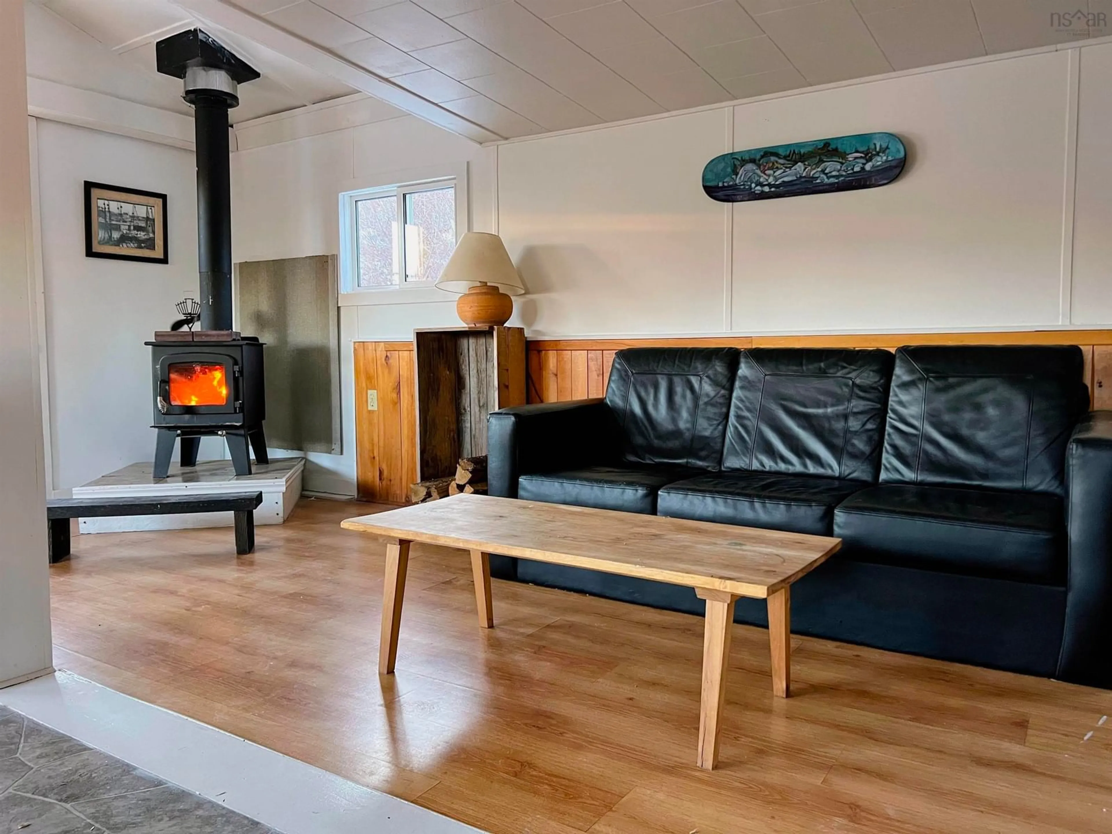 Living room with furniture, wood/laminate floor for 876 Shore Rd, Moose Harbour Nova Scotia B0T 1K0