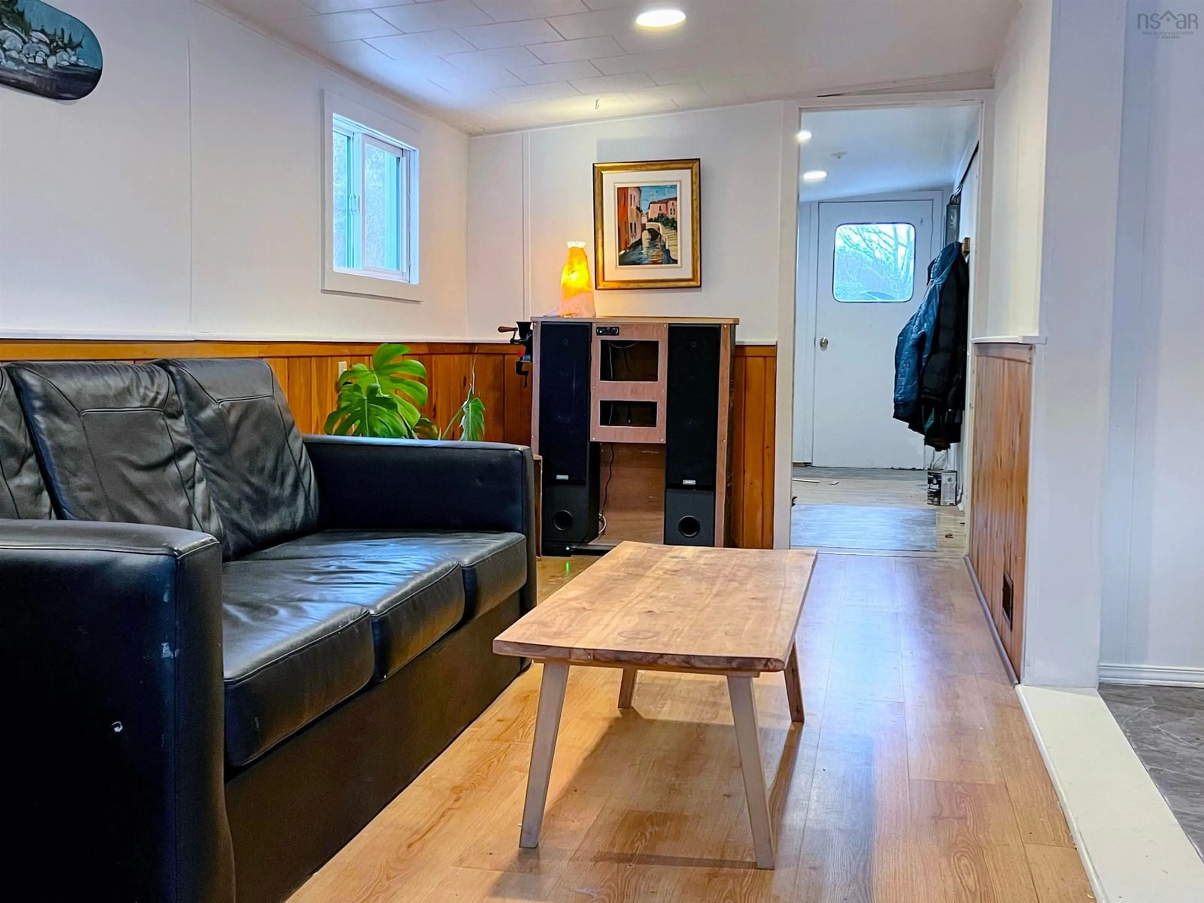 Living room with furniture, wood/laminate floor for 876 Shore Rd, Moose Harbour Nova Scotia B0T 1K0