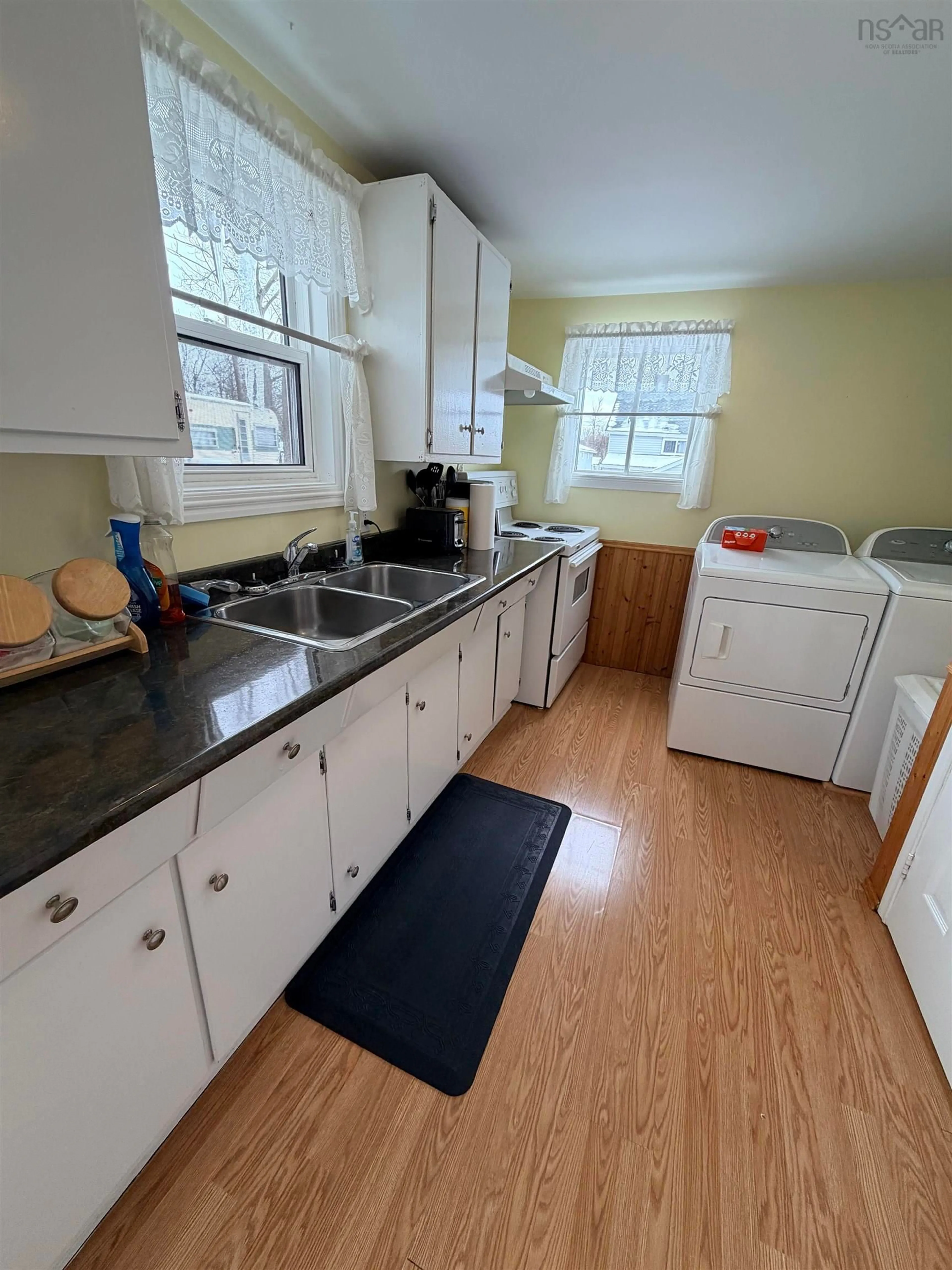 Kitchen with laundary machines, unknown for 3522/3524 Warren Ave, New Waterford Nova Scotia B1H 1R9
