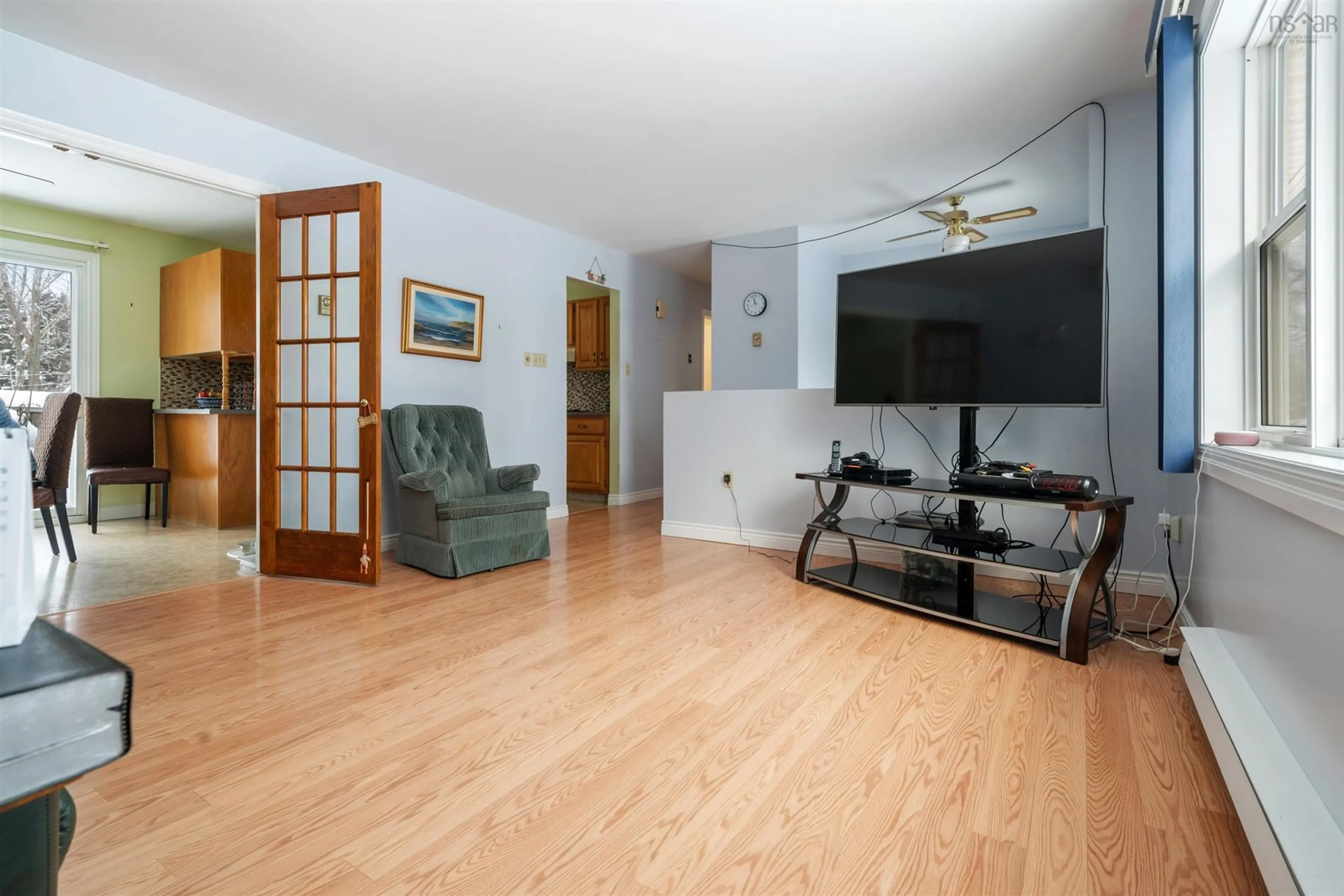 Living room with furniture, wood/laminate floor for 19 Powell Rd, Little Harbour Nova Scotia B2H 5C4