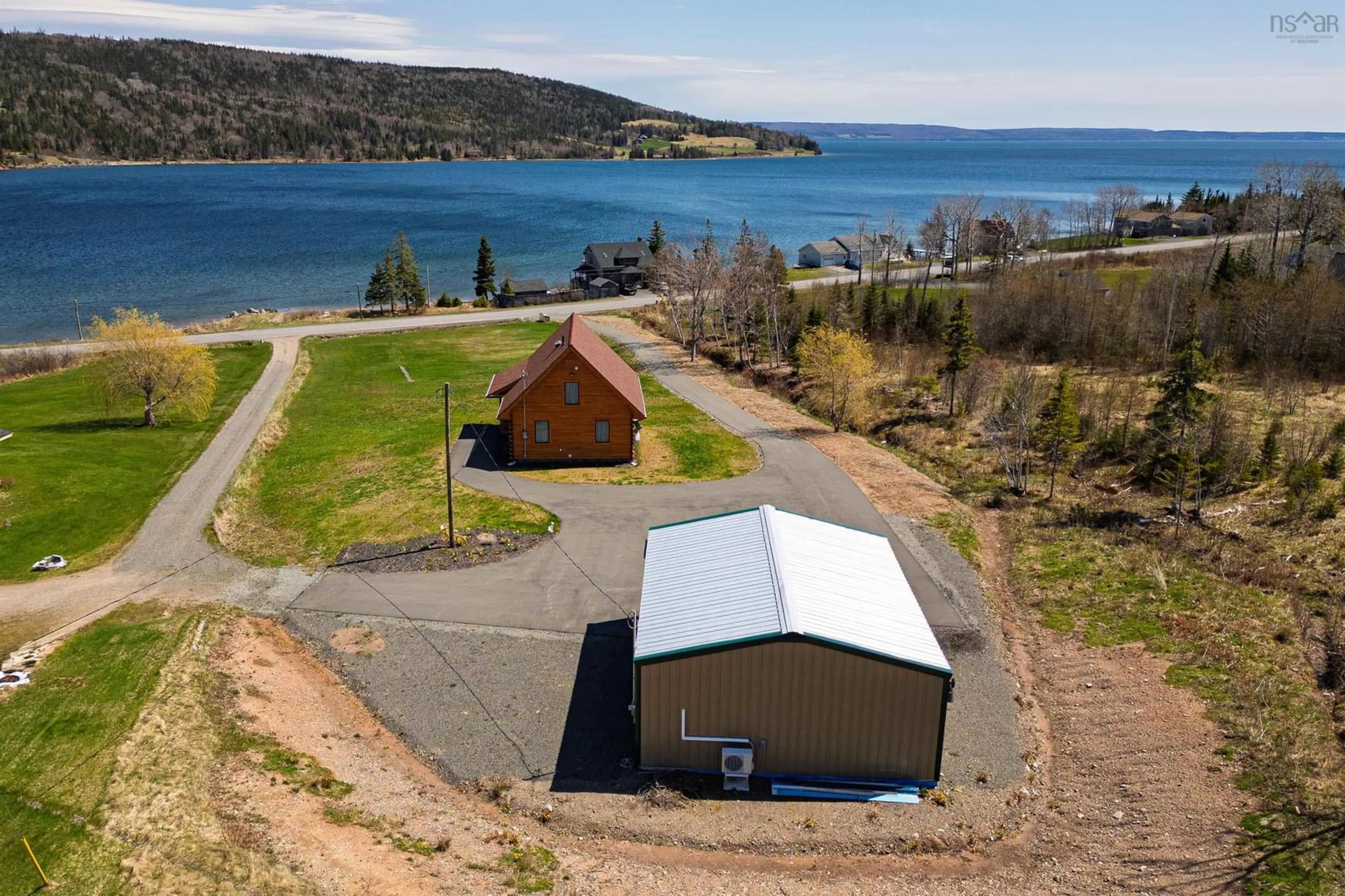 A pic from outside/outdoor area/front of a property/back of a property/a pic from drone, water/lake/river/ocean view for 1005 205 Hwy, Baddeck Nova Scotia B0E 1B0
