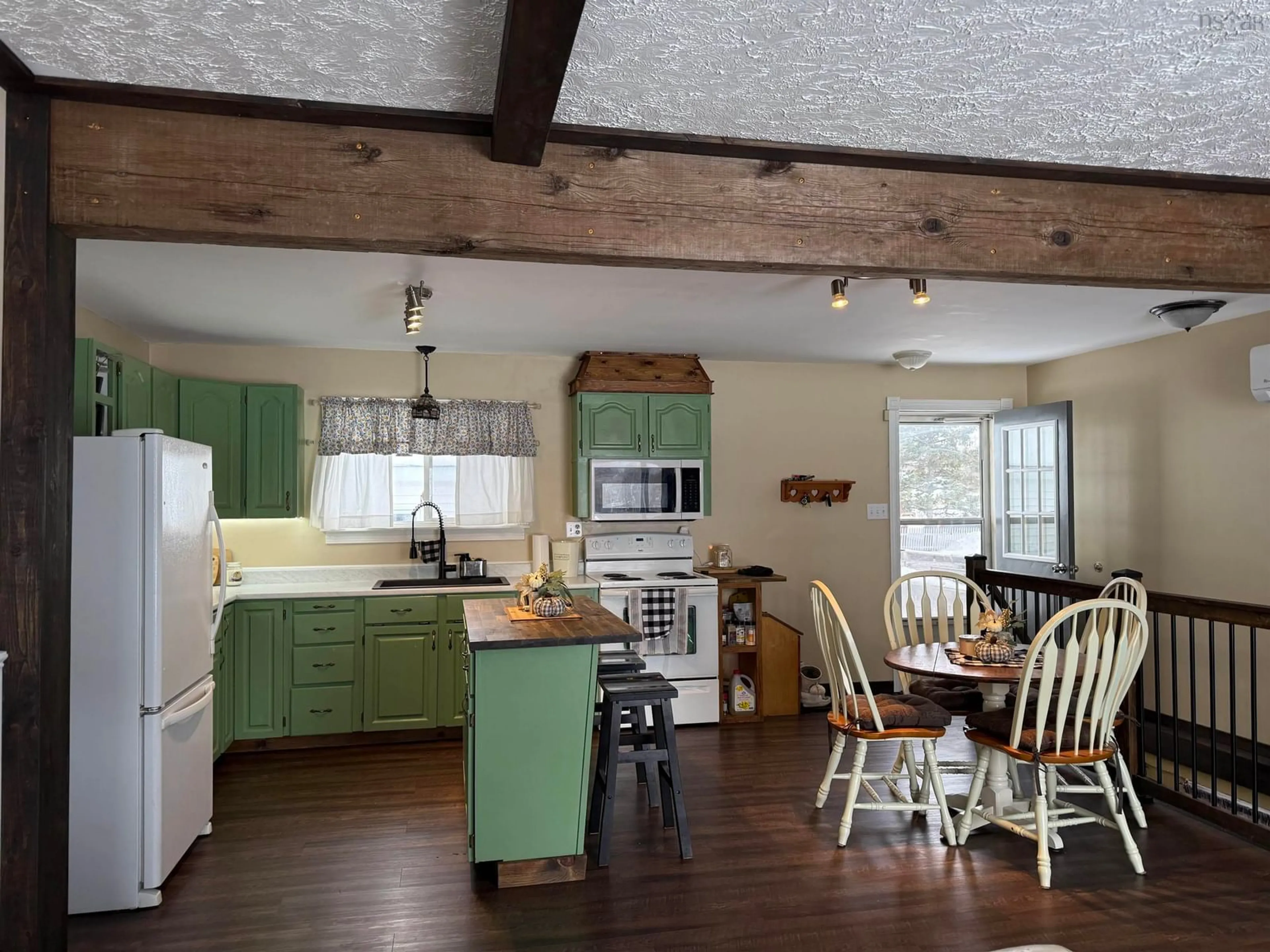 Open concept kitchen, wood/laminate floor for 1668 Mackay St, Westville Nova Scotia B0K 2A0