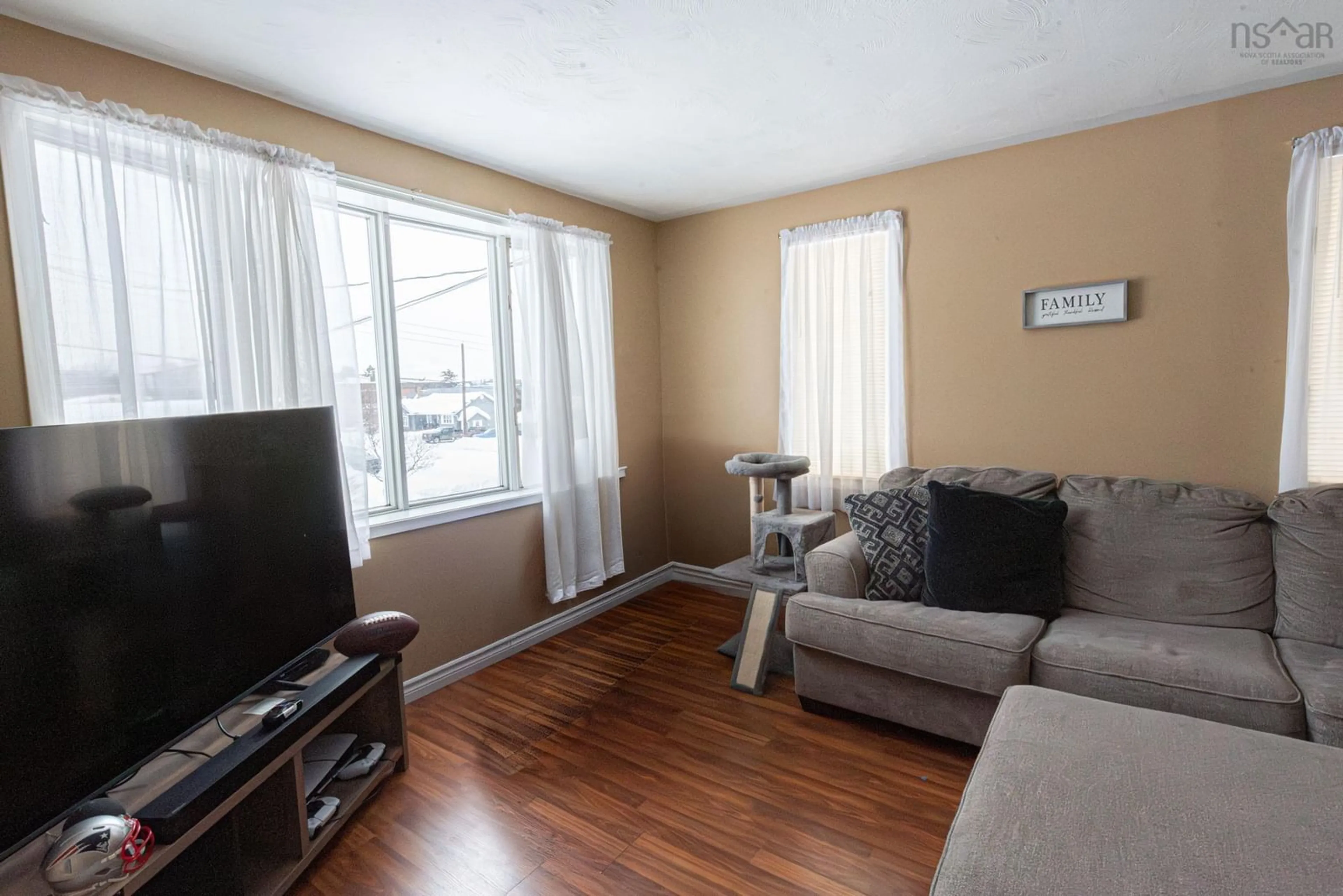 Living room with furniture, wood/laminate floor for 9 Terrace Ave, Stellarton Nova Scotia B0K 1S0