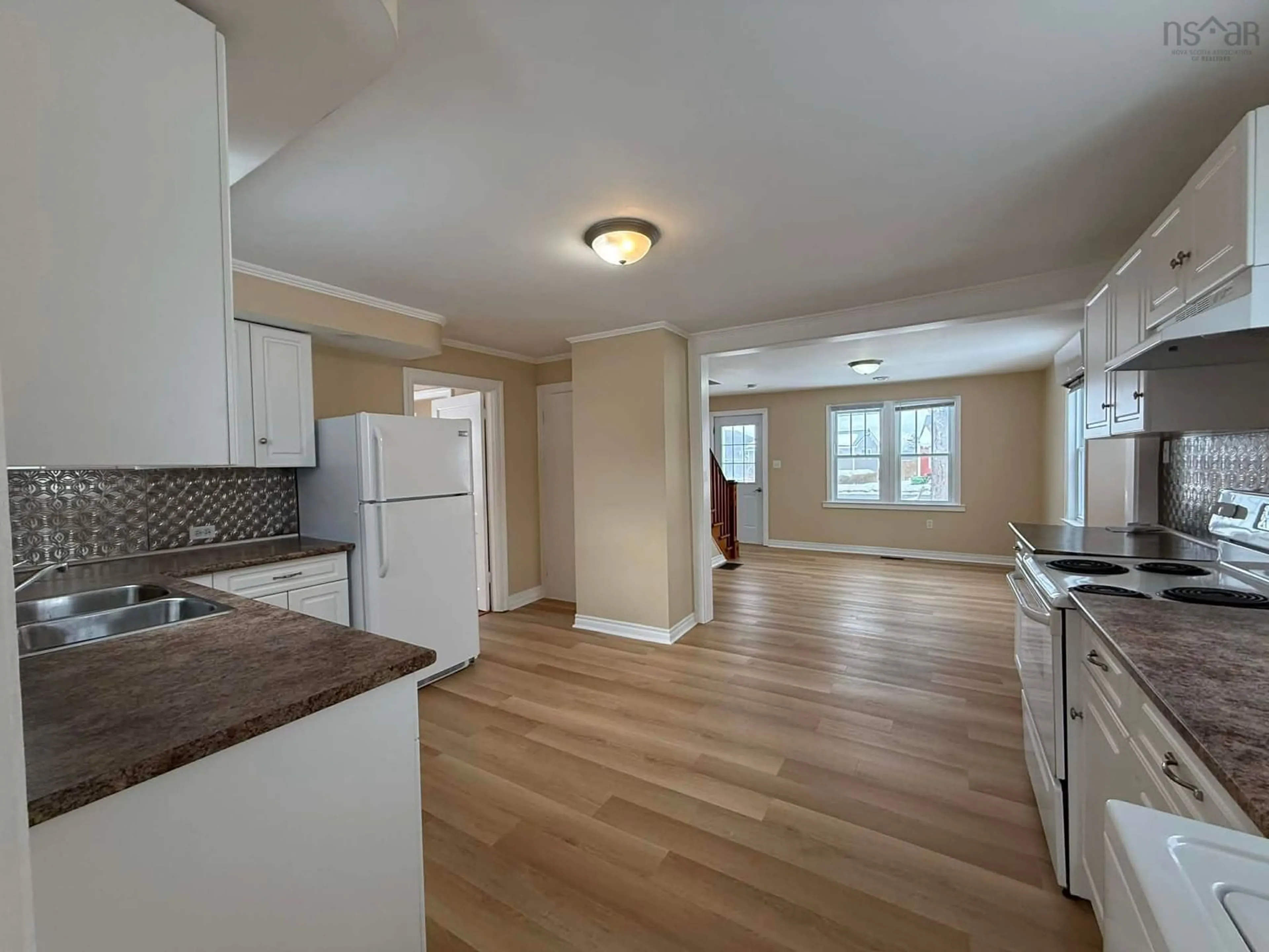 Open concept kitchen, wood/laminate floor for 21 South St, Carleton Corner Nova Scotia B0S 1C0