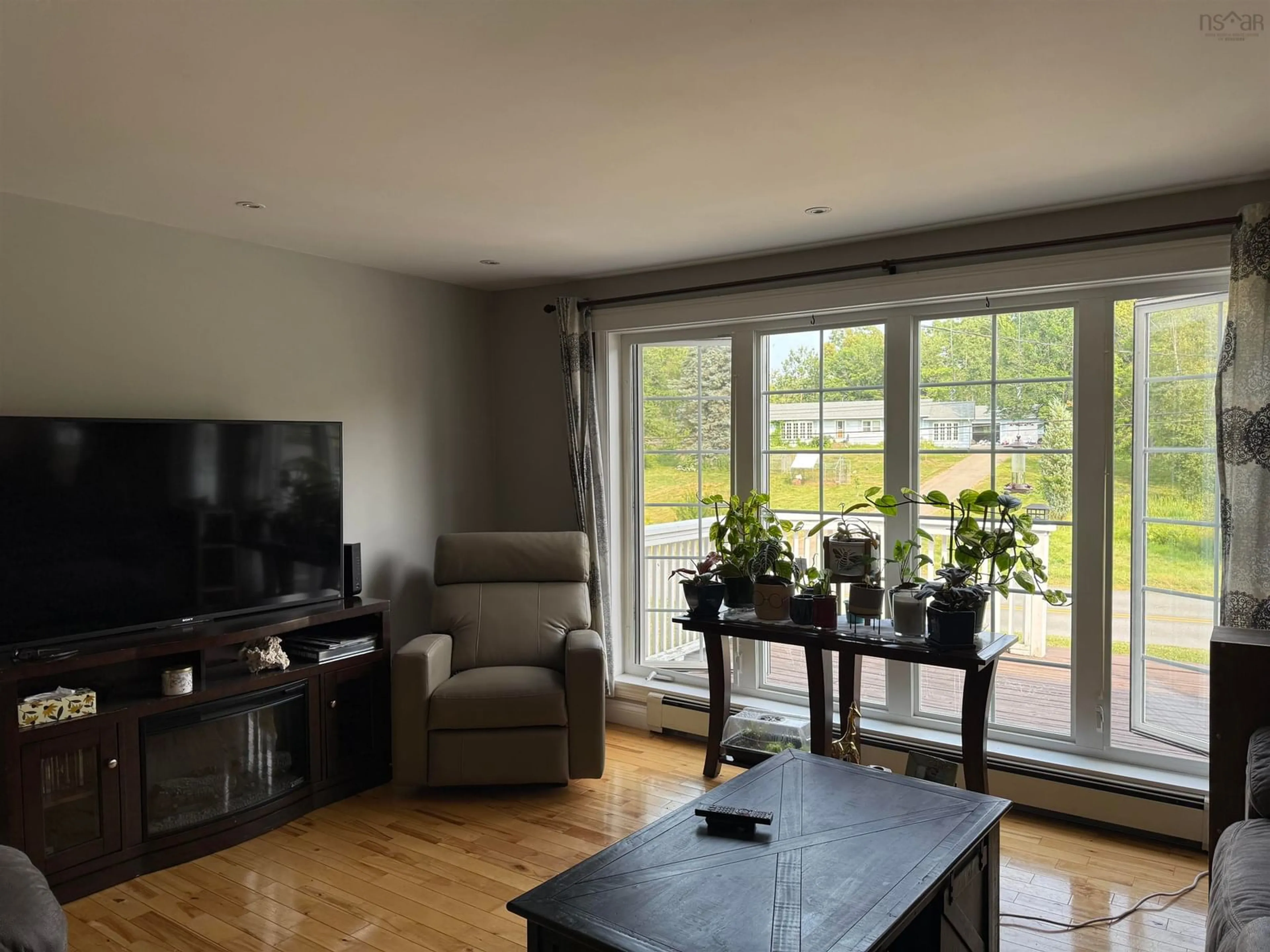 Living room with furniture, wood/laminate floor for 123 Chance Harbour Rd, Hillside Nova Scotia B0K 1X0