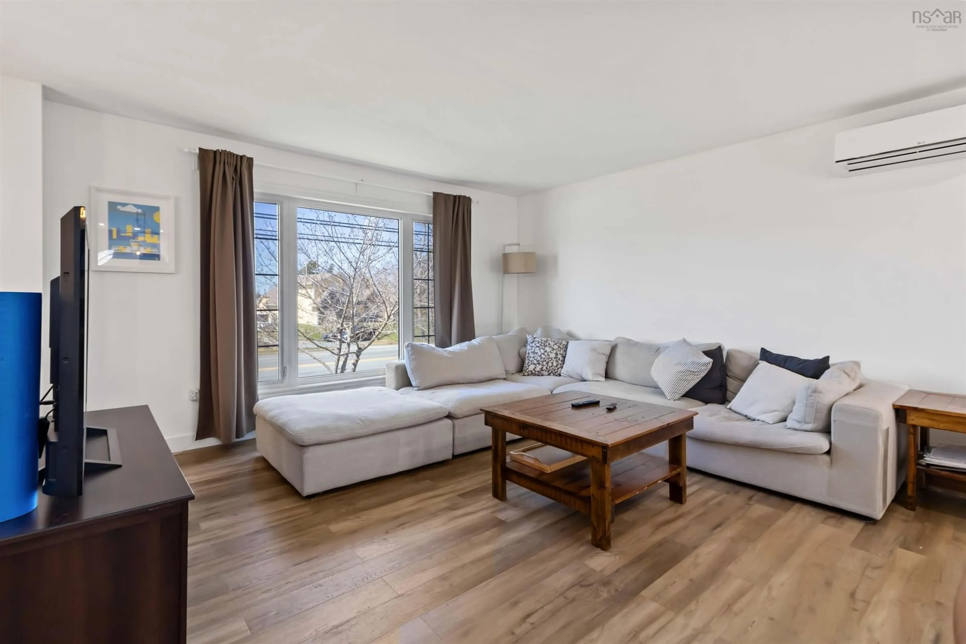 Living room with furniture, wood/laminate floor for 682 Caldwell Rd, Colby Village Nova Scotia B2V 1L1