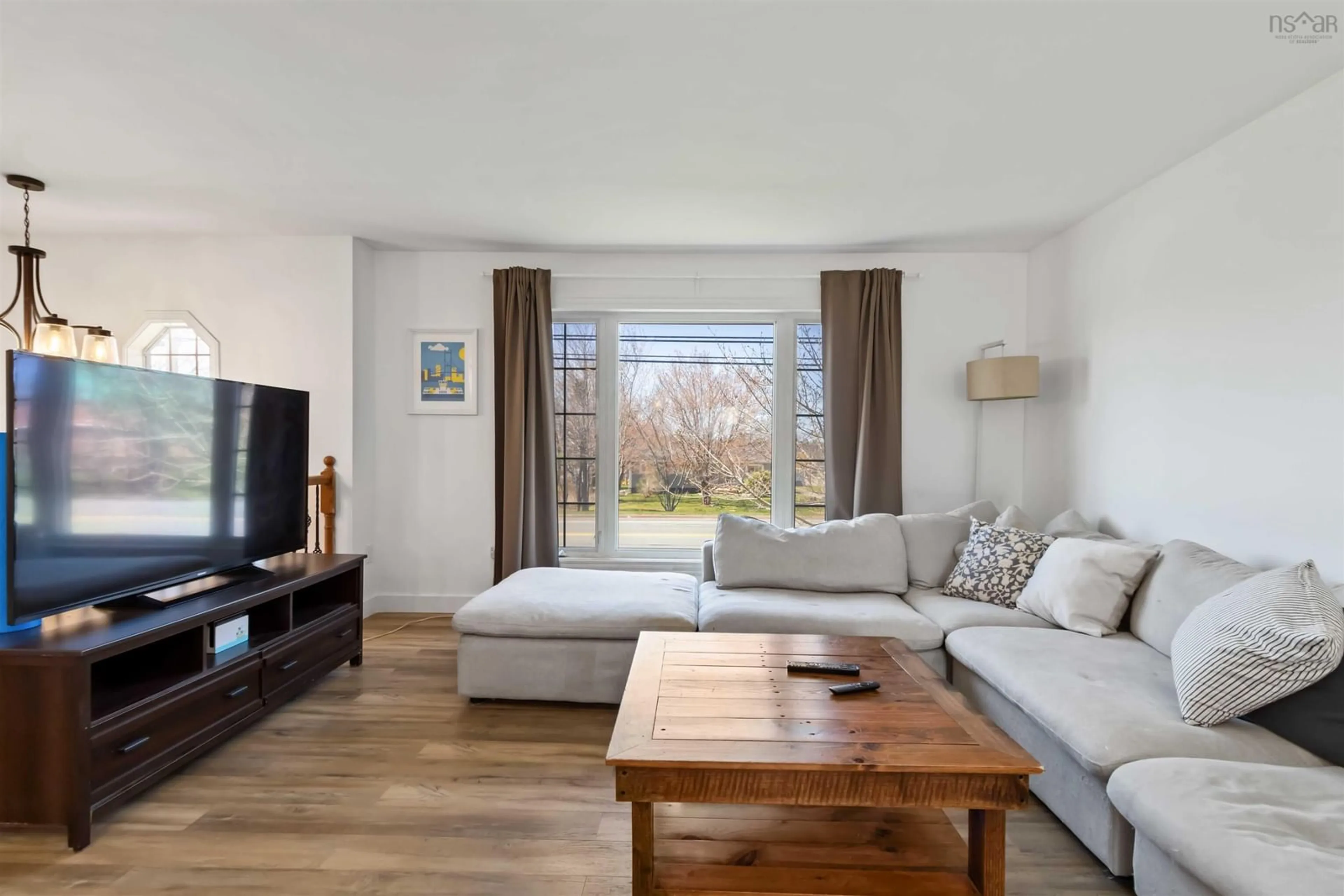 Living room with furniture, wood/laminate floor for 682 Caldwell Rd, Colby Village Nova Scotia B2V 1L1