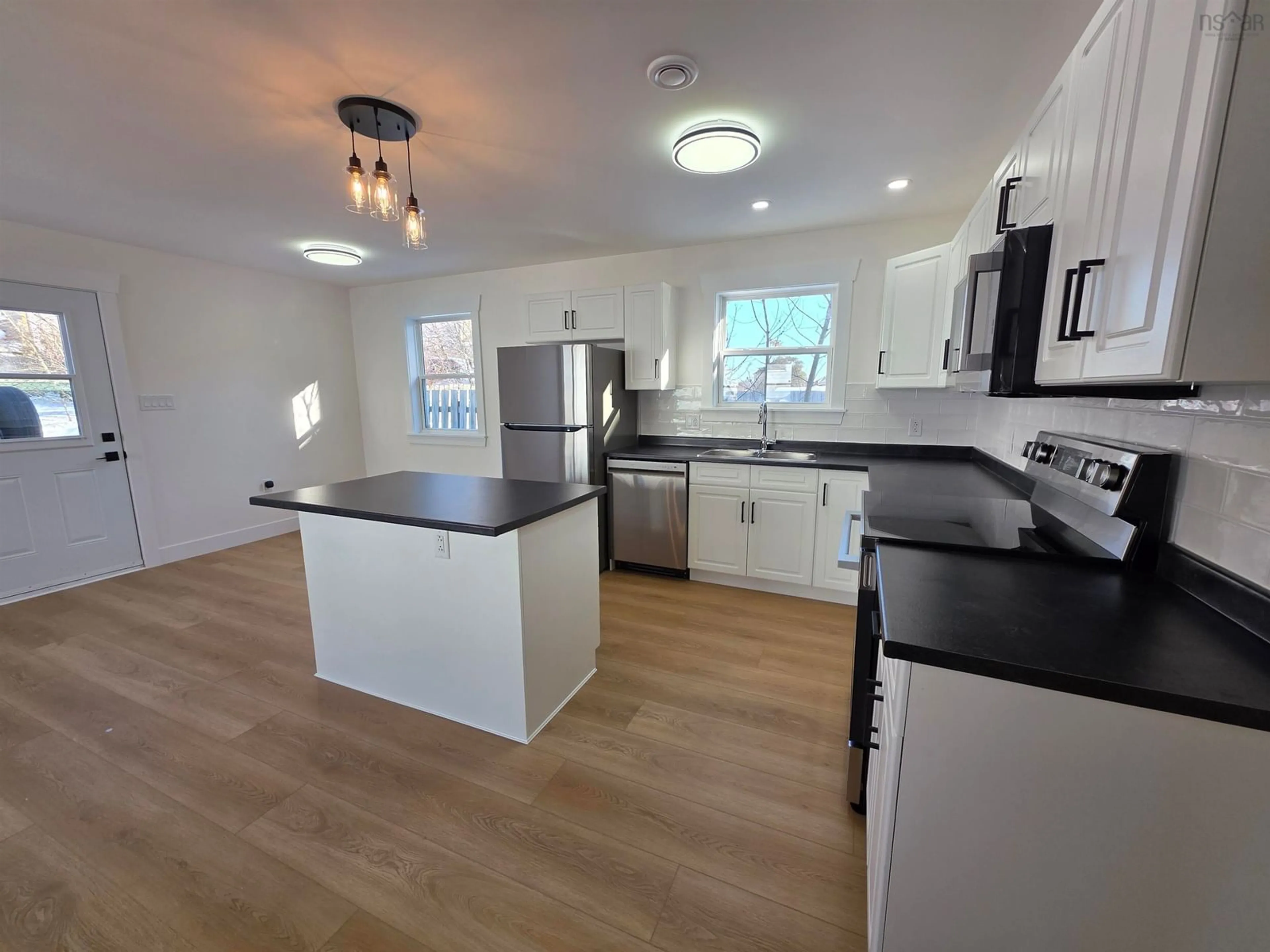 Open concept kitchen, wood/laminate floor for 6 South St, Sydney Nova Scotia B1N 2M3