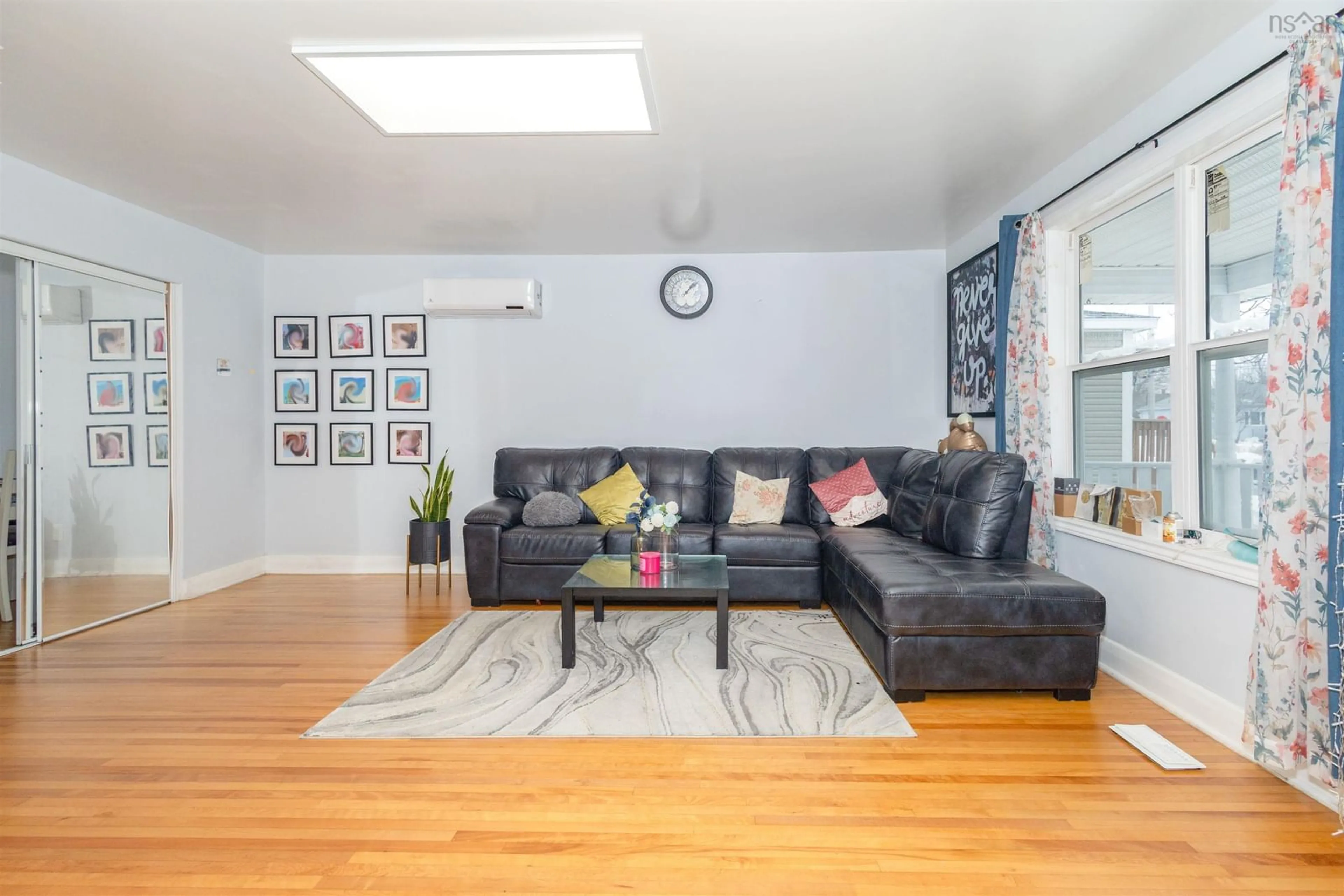 Living room with furniture, wood/laminate floor for 31 Stornaway St, Ashby Nova Scotia B1P 2P7