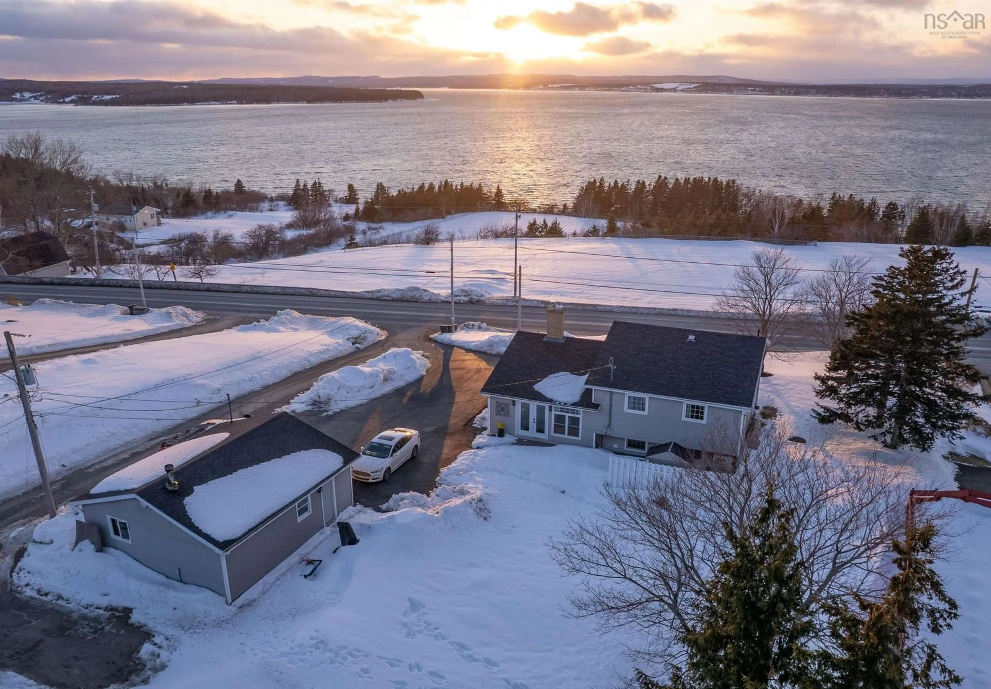 A pic from outside/outdoor area/front of a property/back of a property/a pic from drone, water/lake/river/ocean view for 2182 New Waterford Hwy, South Bar Nova Scotia B1N 3H7