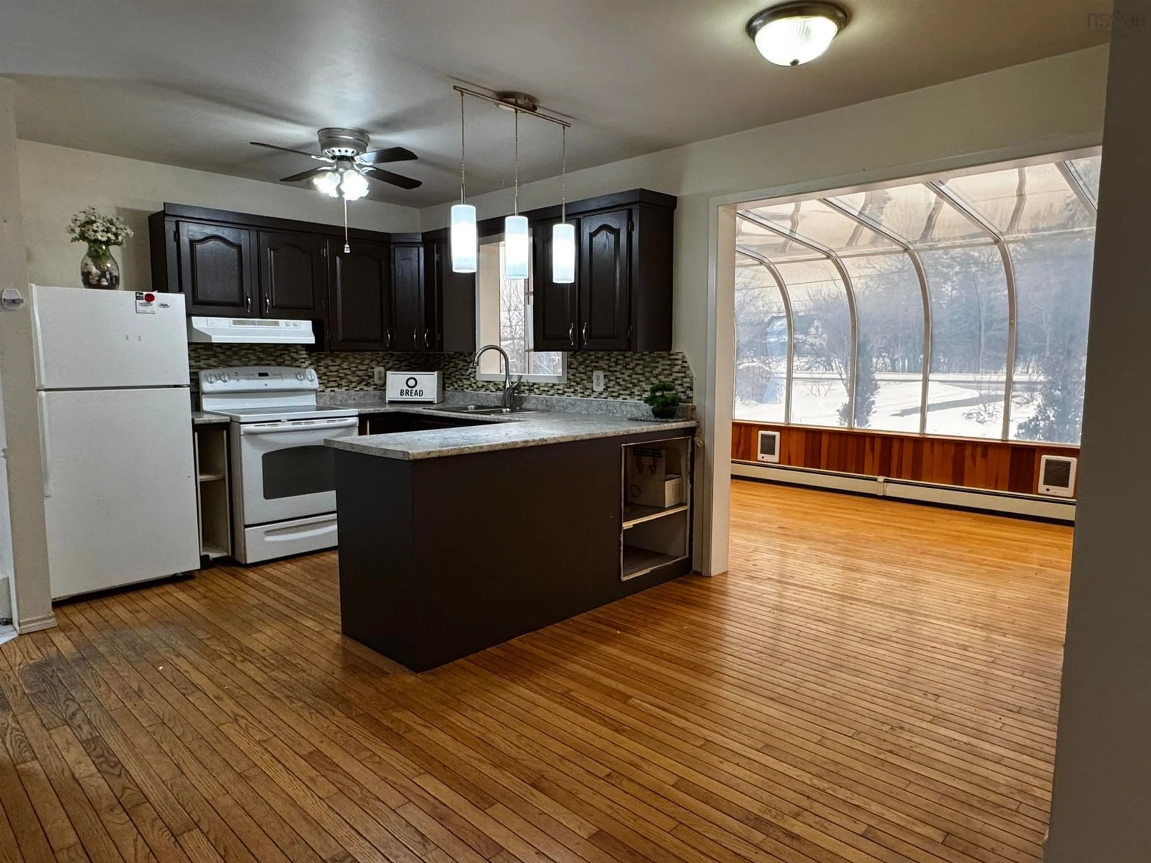 Open concept kitchen, wood/laminate floor for 6221 Seaside Dr, Gardiner Mines Nova Scotia B1H 5K4