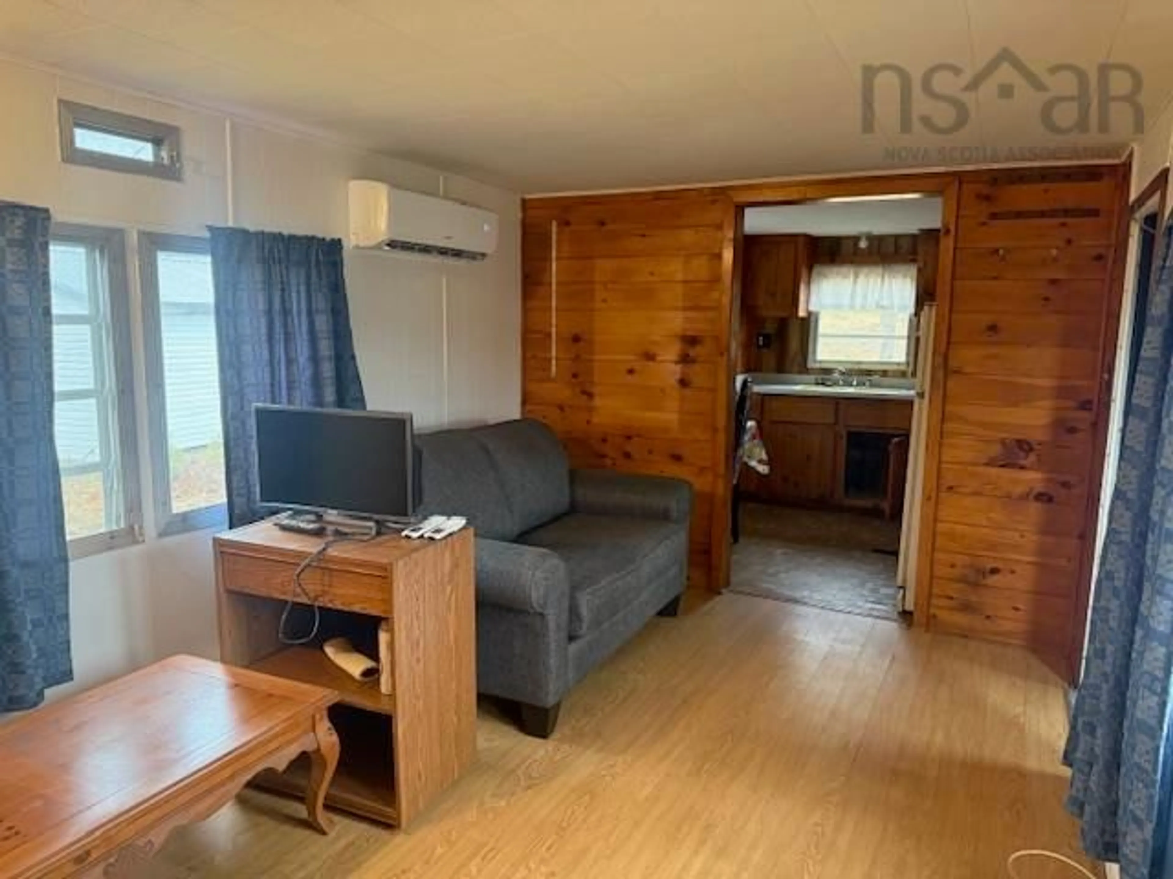 Living room with furniture, wood/laminate floor for 800 Highway 208, Simpsons Corner Nova Scotia B0R 1E0
