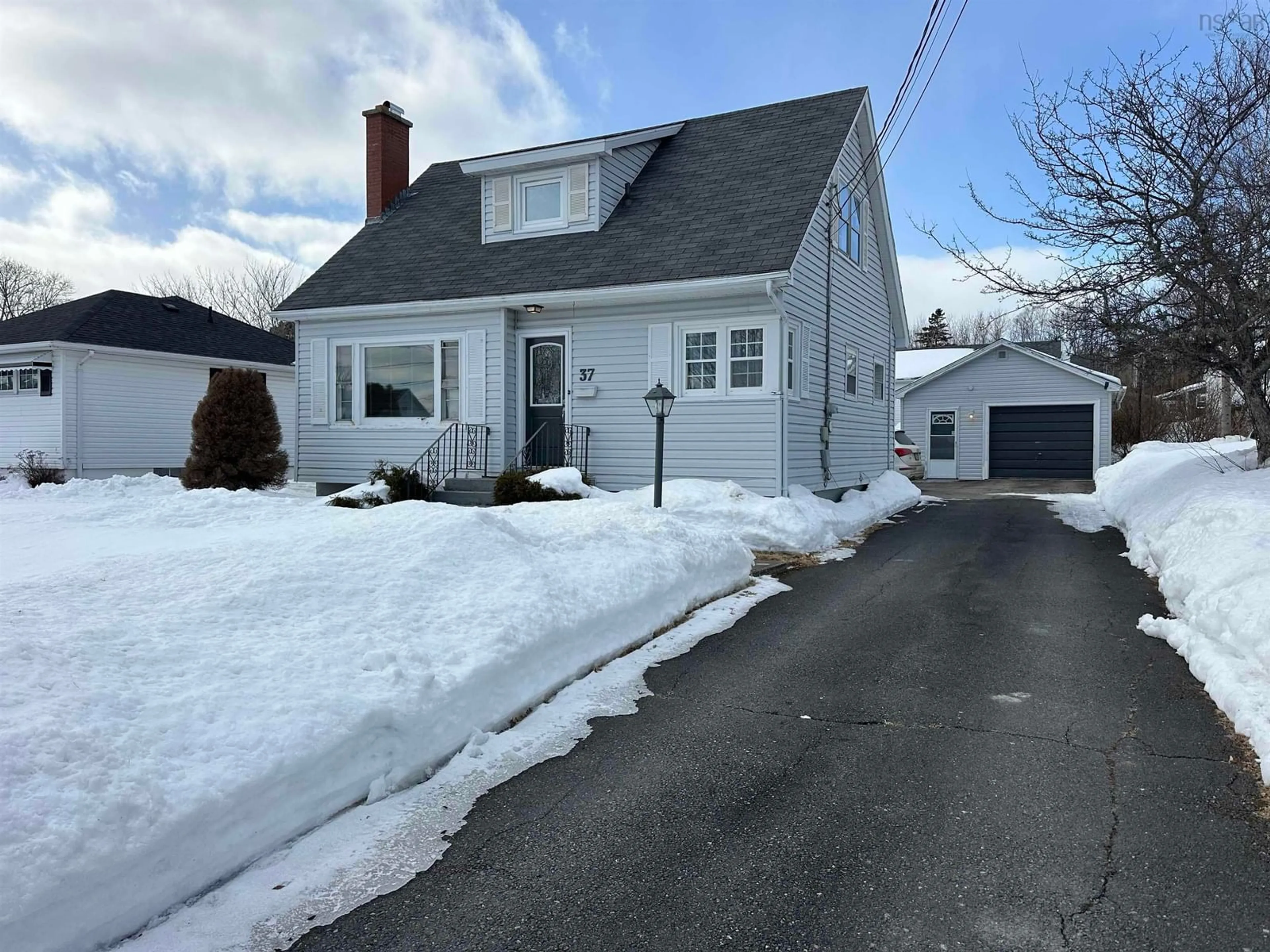 A pic from outside/outdoor area/front of a property/back of a property/a pic from drone, street for 37 Kelmere Dr, Sydney River Nova Scotia B1R 1P9
