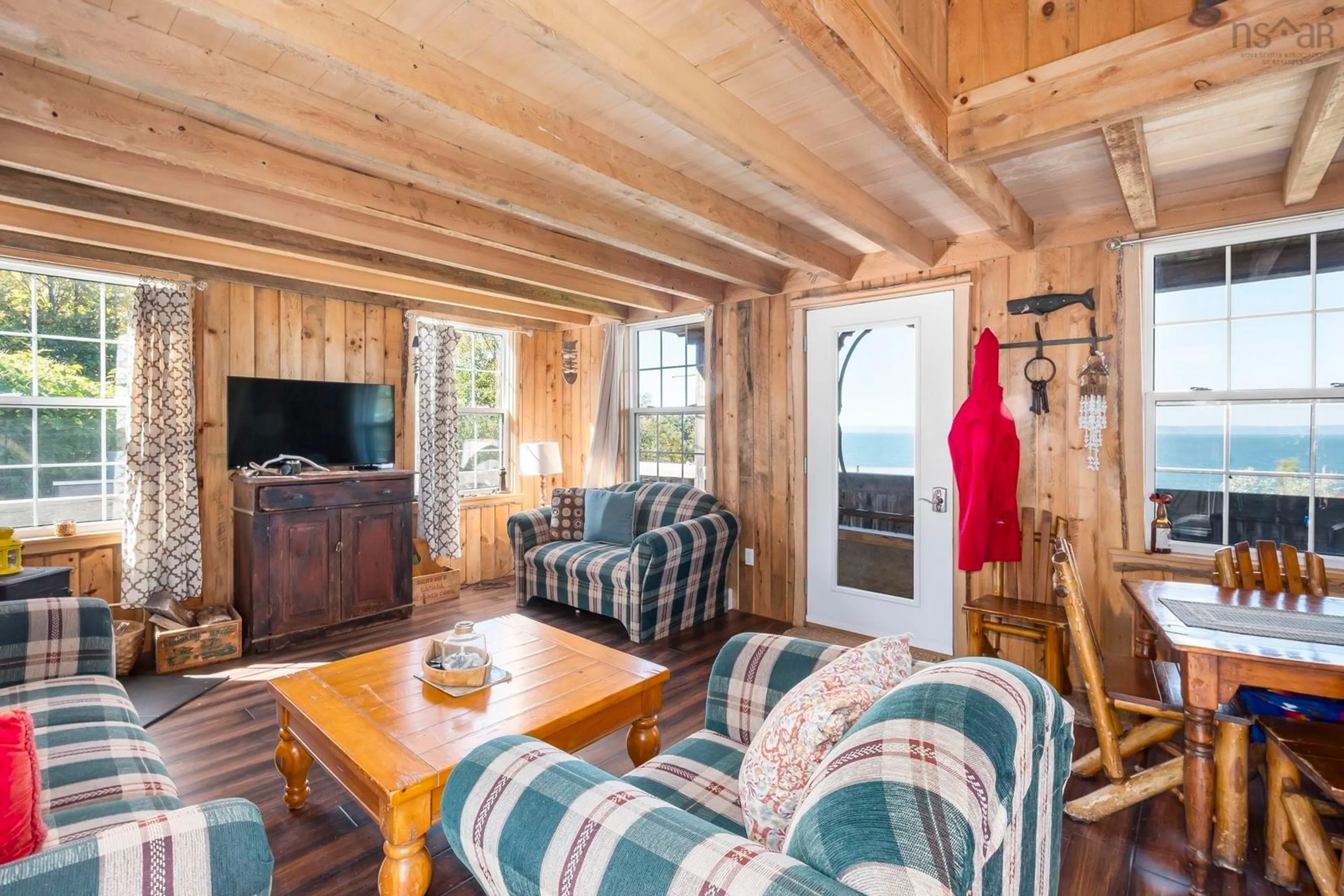 Living room with furniture, wood/laminate floor for 54 Cove Rd, Halls Harbour Nova Scotia B0P 1J0