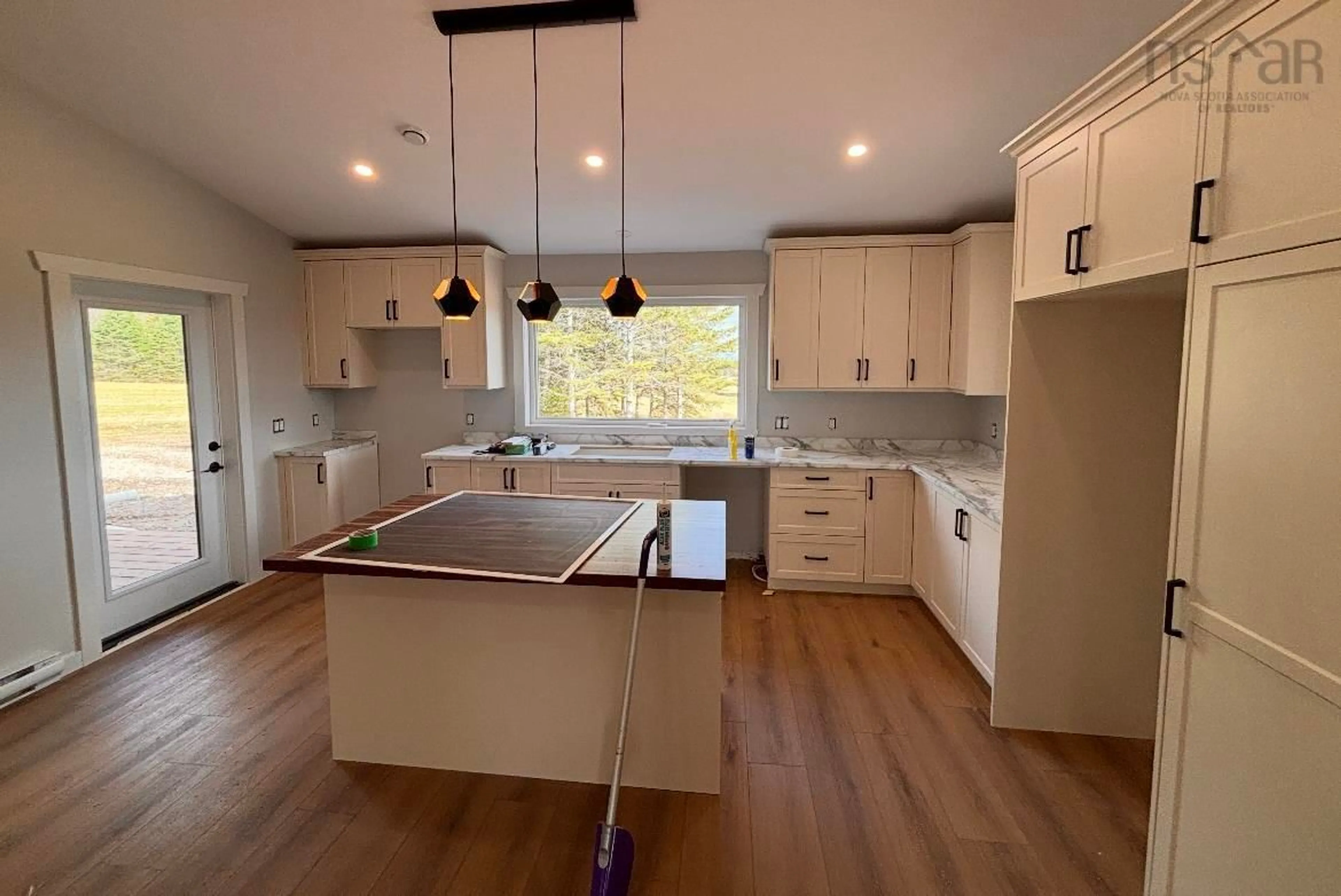 Open concept kitchen, wood/laminate floor for 28 Main St, Gore Nova Scotia B0W 2N0