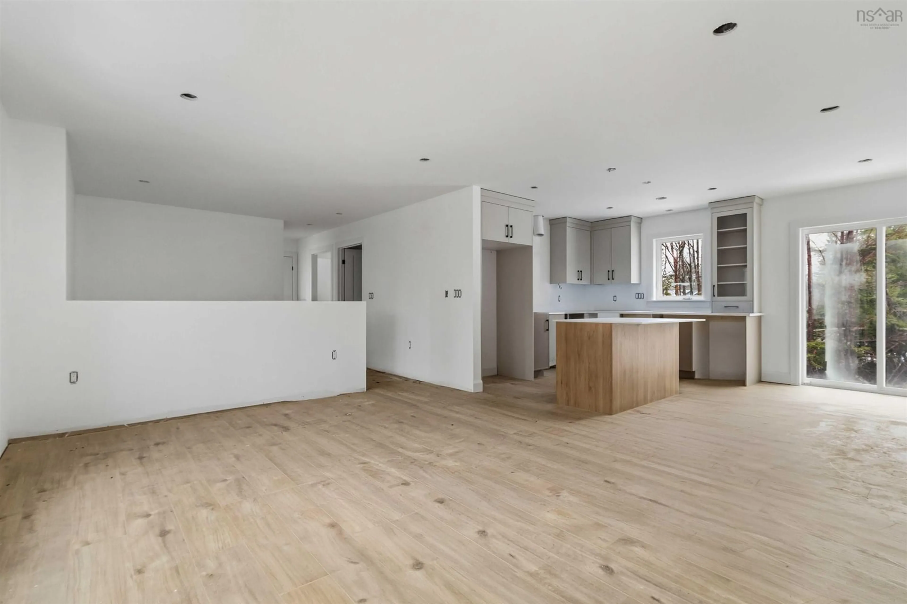 Open concept kitchen, wood/laminate floor for 23 Verbena Crt, Porters Lake Nova Scotia B3E 0B7