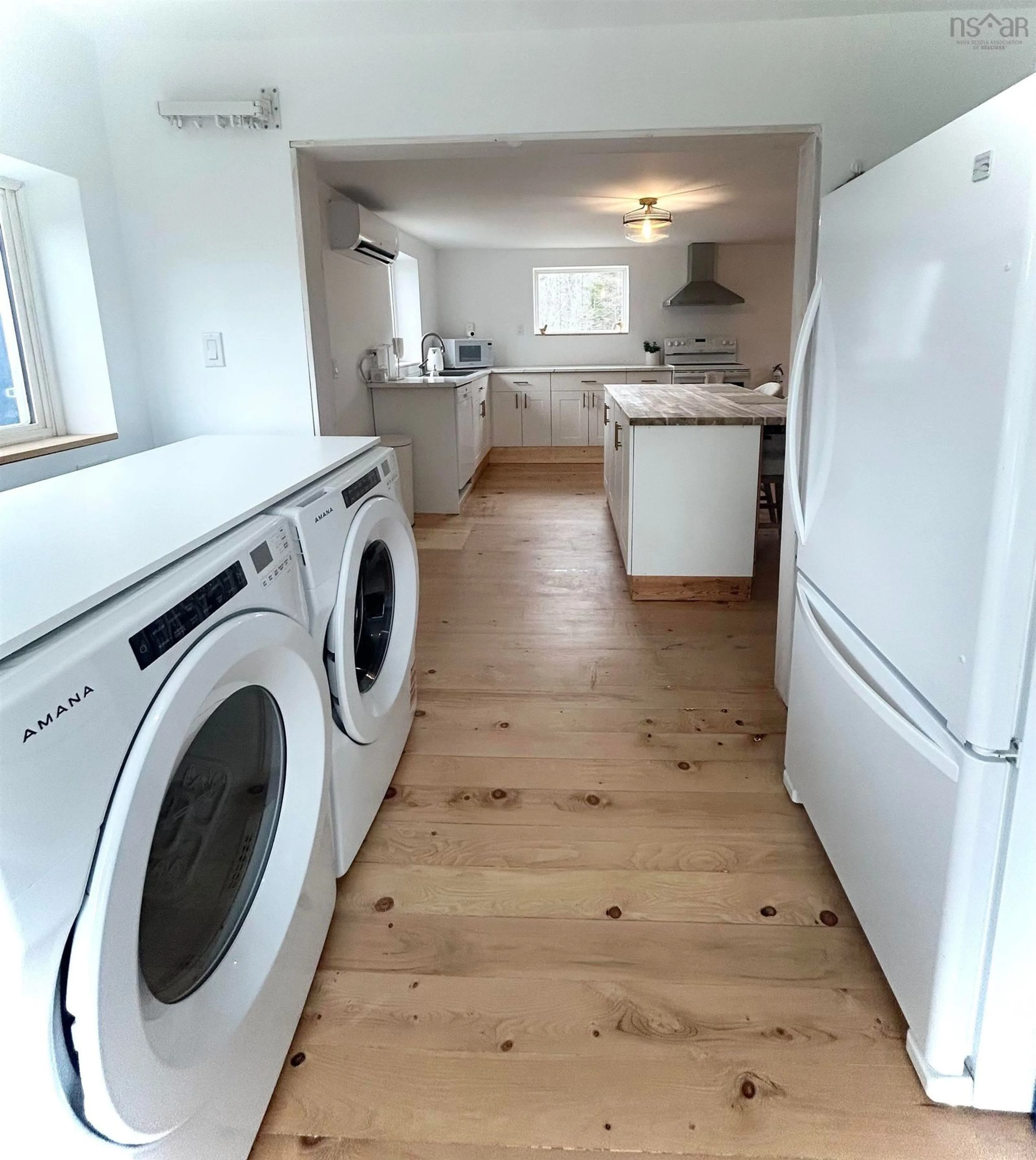 Kitchen with laundary machines, wood/laminate floor for 1318 Sweetland Rd, Sweetland Nova Scotia B0J 1E0