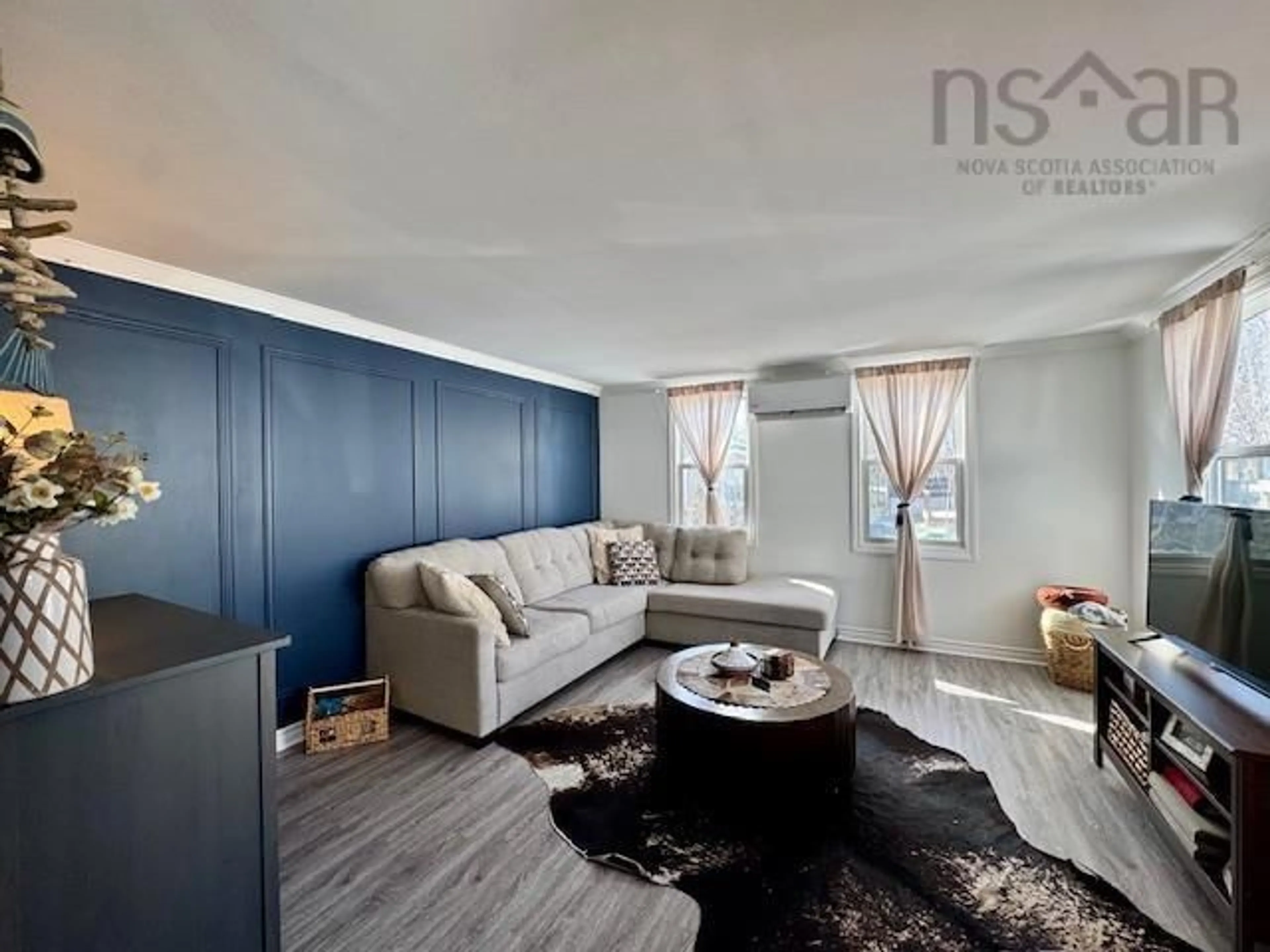 Living room with furniture, wood/laminate floor for 15 Stanley St, Middle Sackville Nova Scotia B4E 1E7