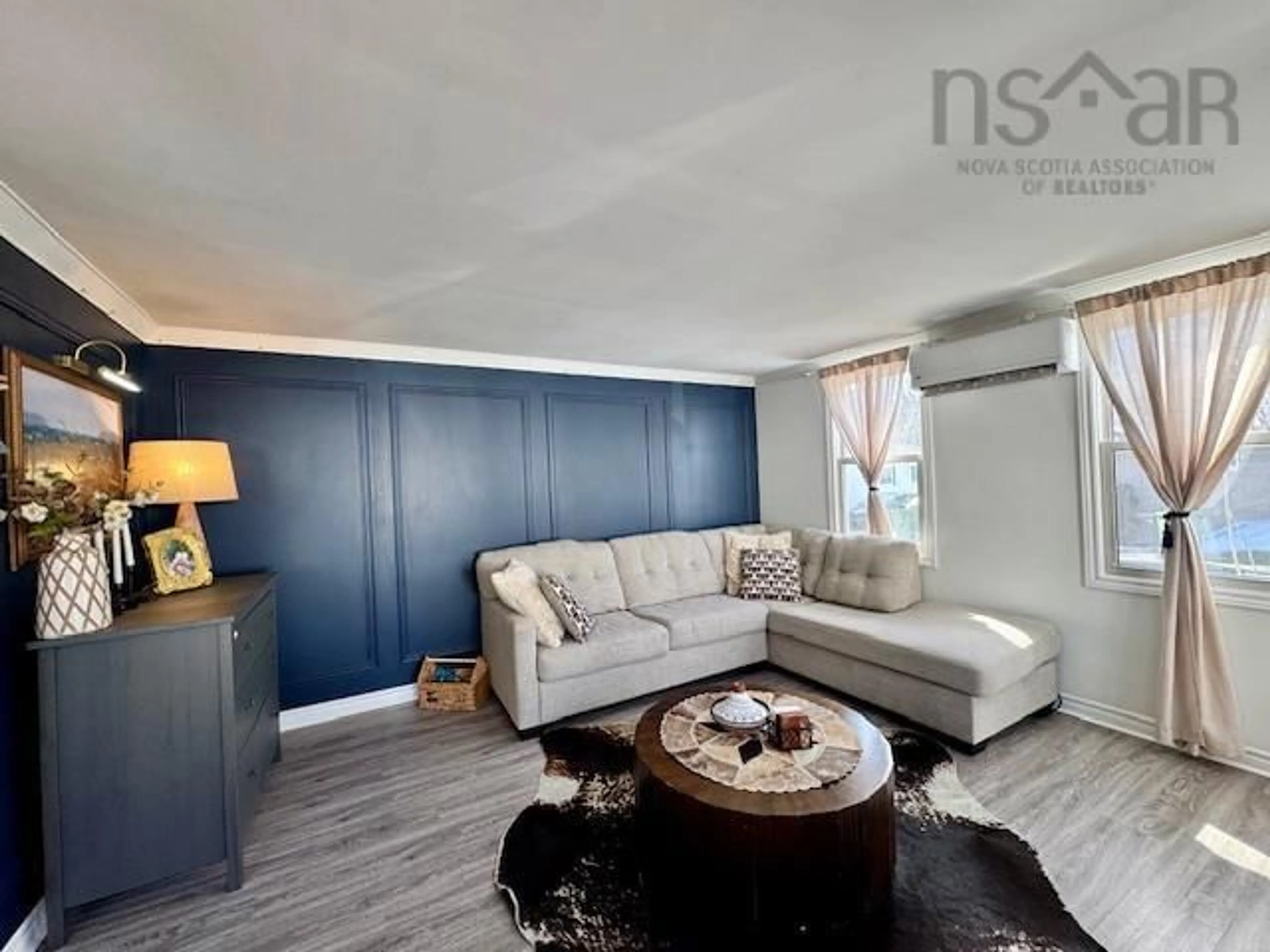 Living room with furniture, wood/laminate floor for 15 Stanley St, Middle Sackville Nova Scotia B4E 1E7