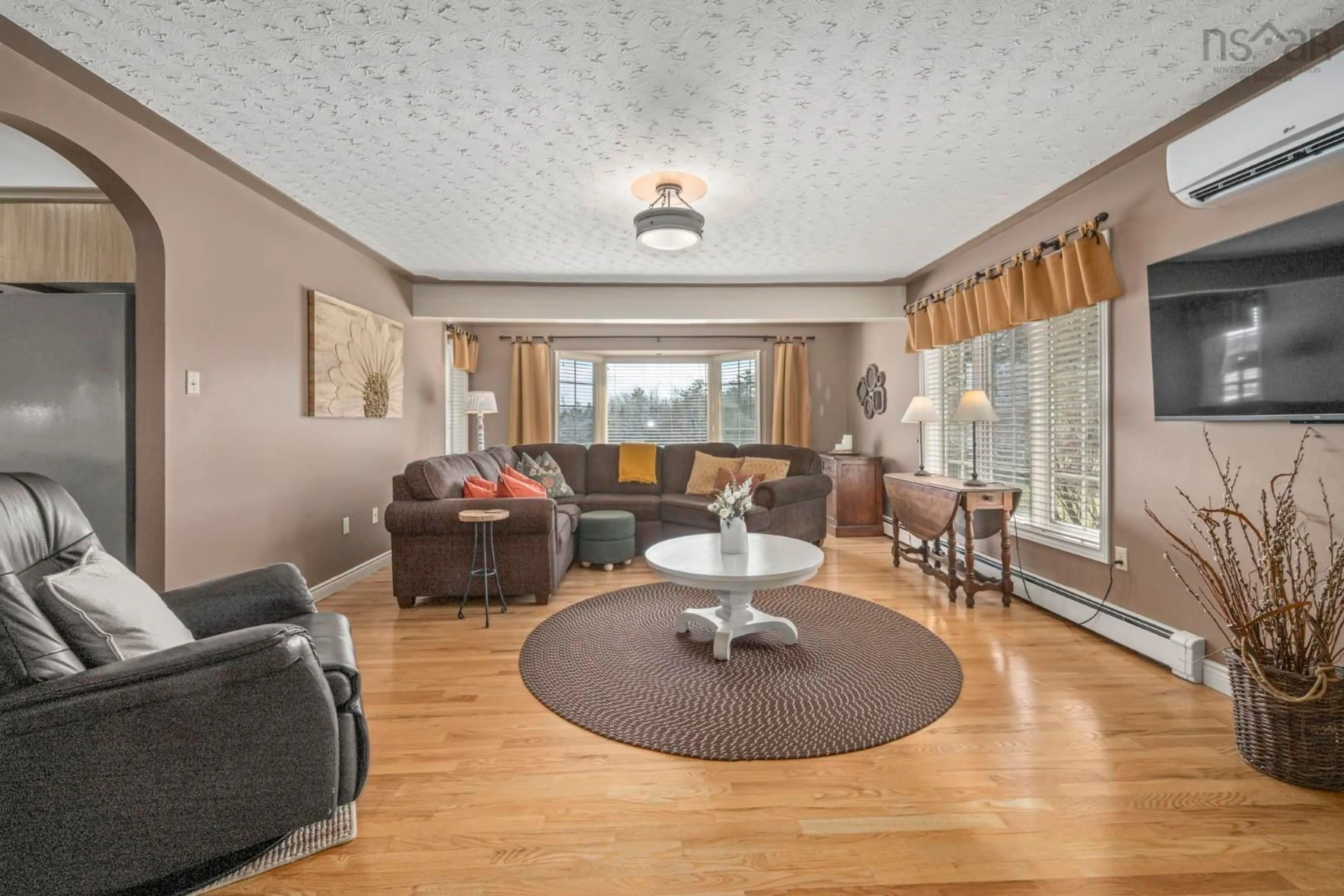 Living room with furniture, wood/laminate floor for 34 Norwood Crt, Porters Lake Nova Scotia B3E 1M1