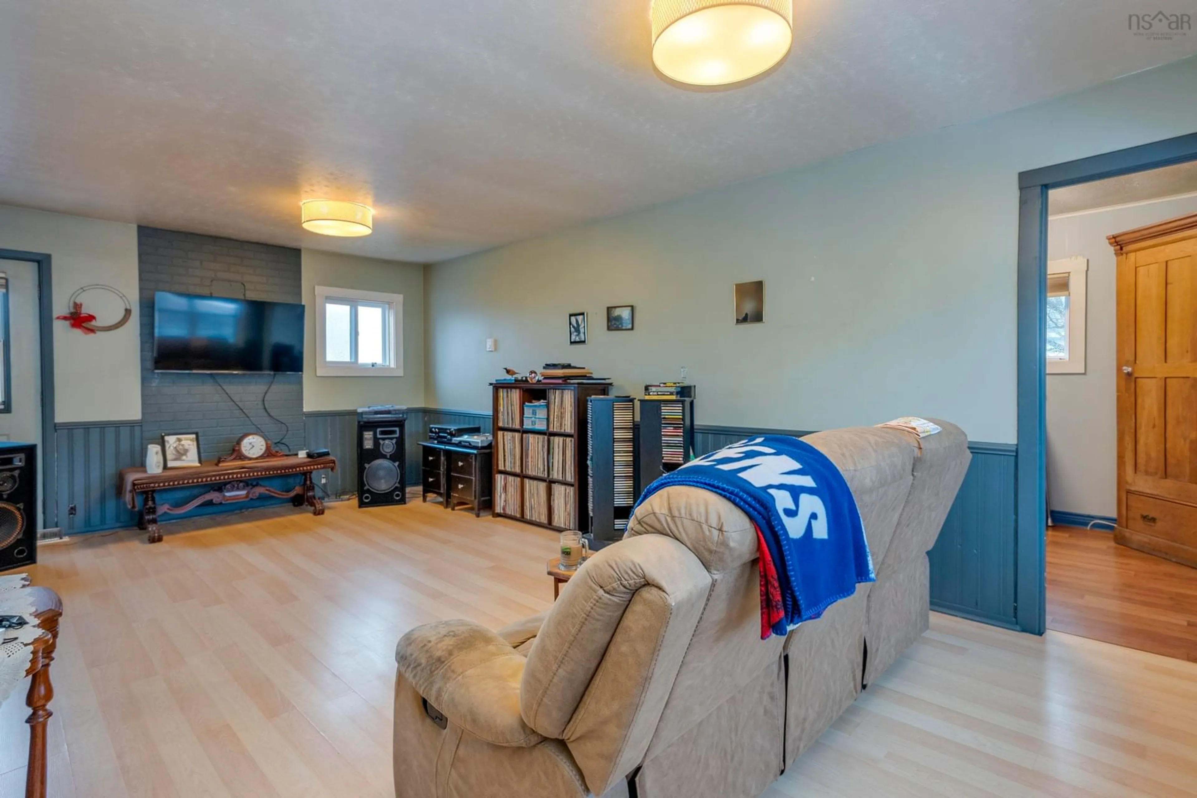 Living room with furniture, wood/laminate floor for 10014 221 Hwy, Habitant Nova Scotia B0P 1H0