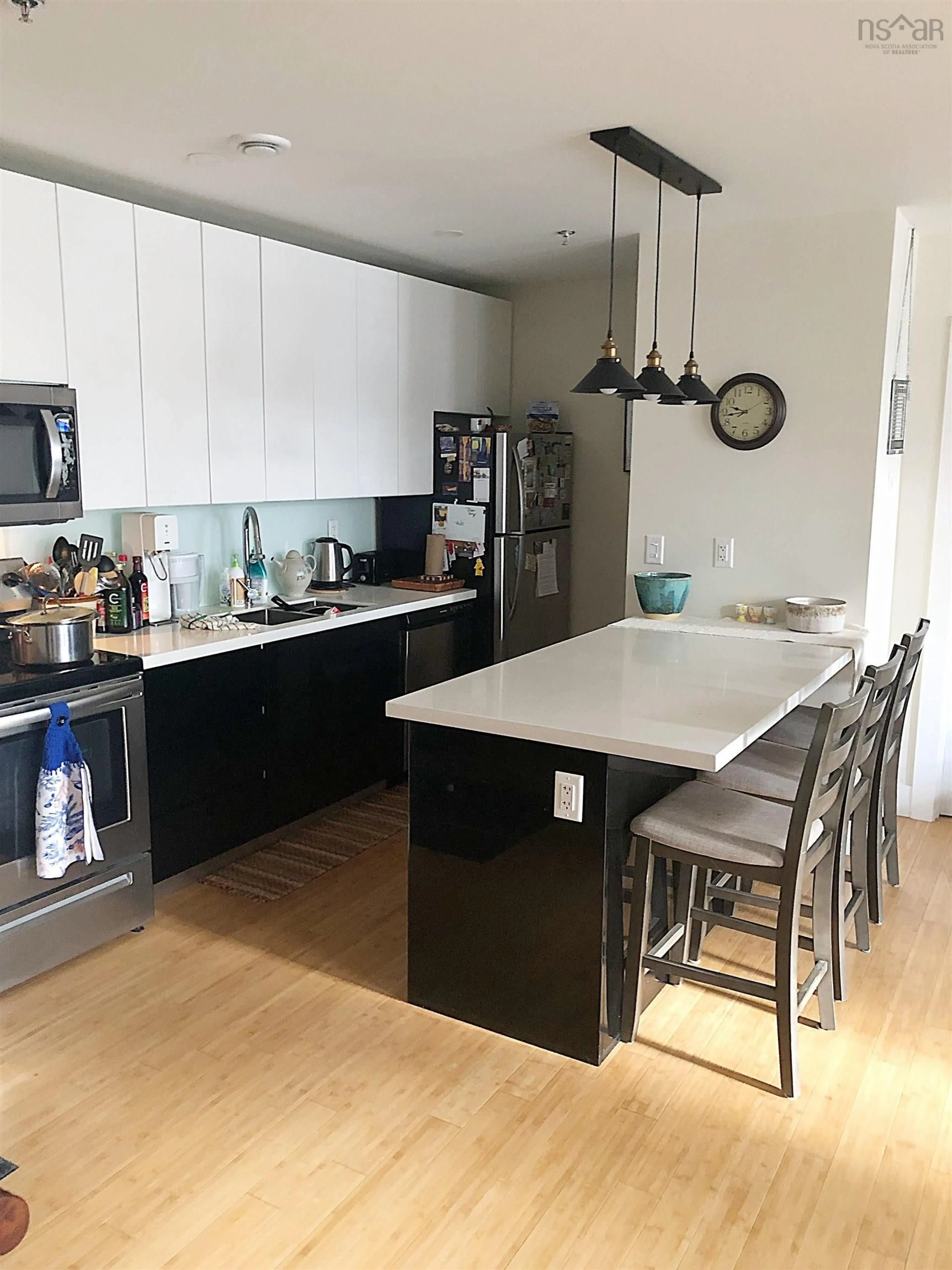 Open concept kitchen, wood/laminate floor for 151 Ritchie St #110, Annapolis Royal Nova Scotia B0S 1A0