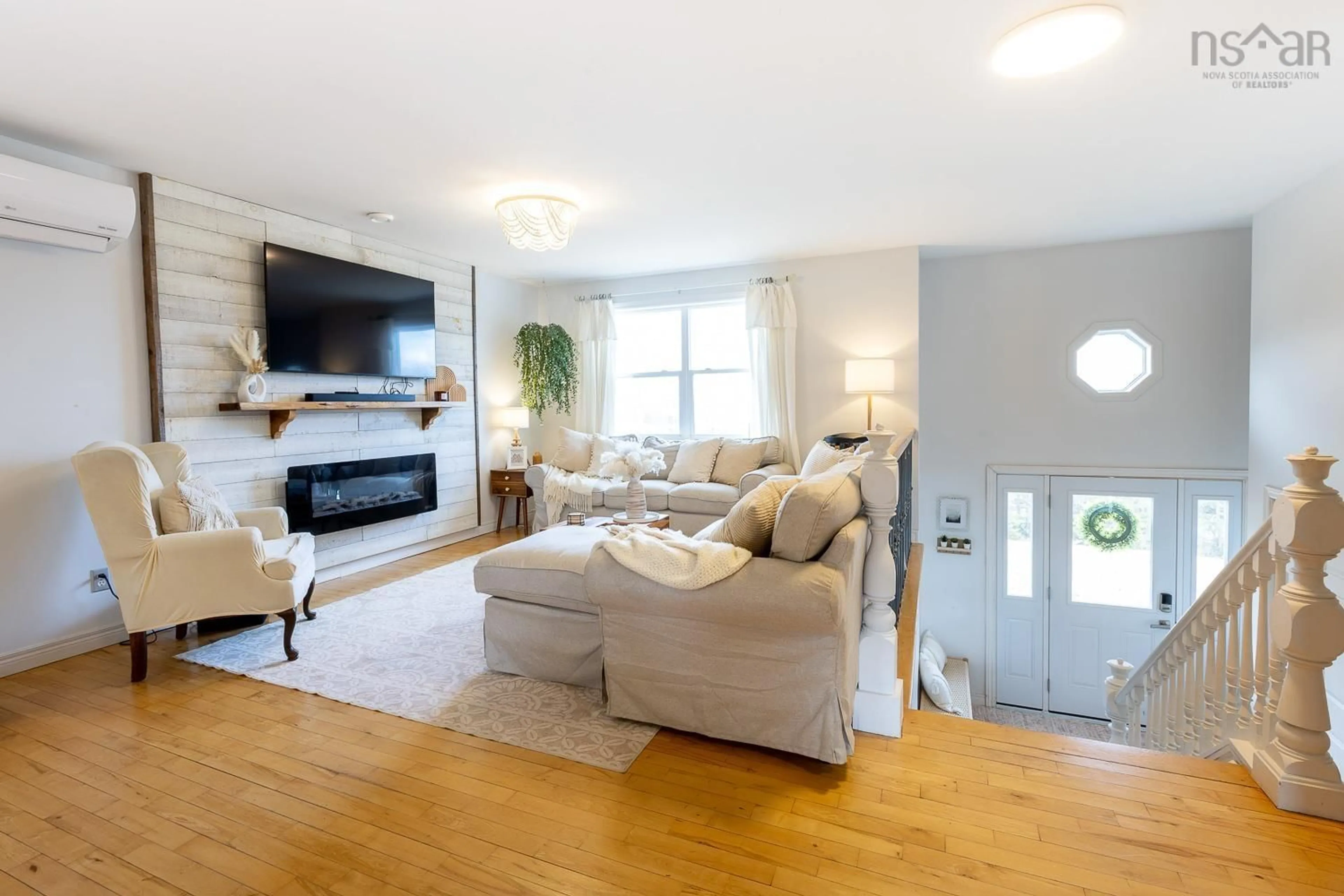 Living room with furniture, wood/laminate floor for 54 Glenabbey Dr, Murray Siding Nova Scotia B6L 3L2