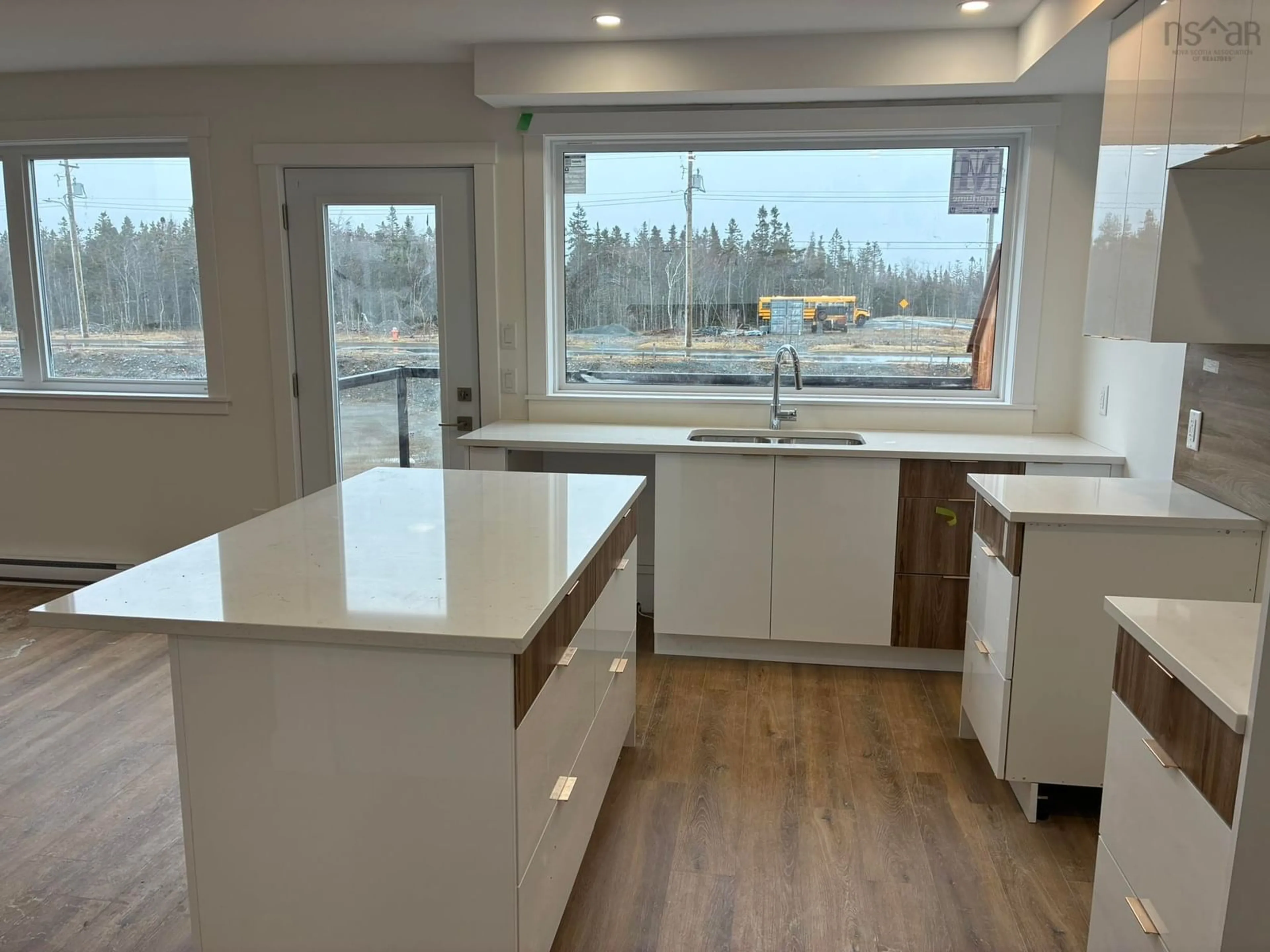 Open concept kitchen, wood/laminate floor for 44 Berm St, Spryfield Nova Scotia B3R 0H2