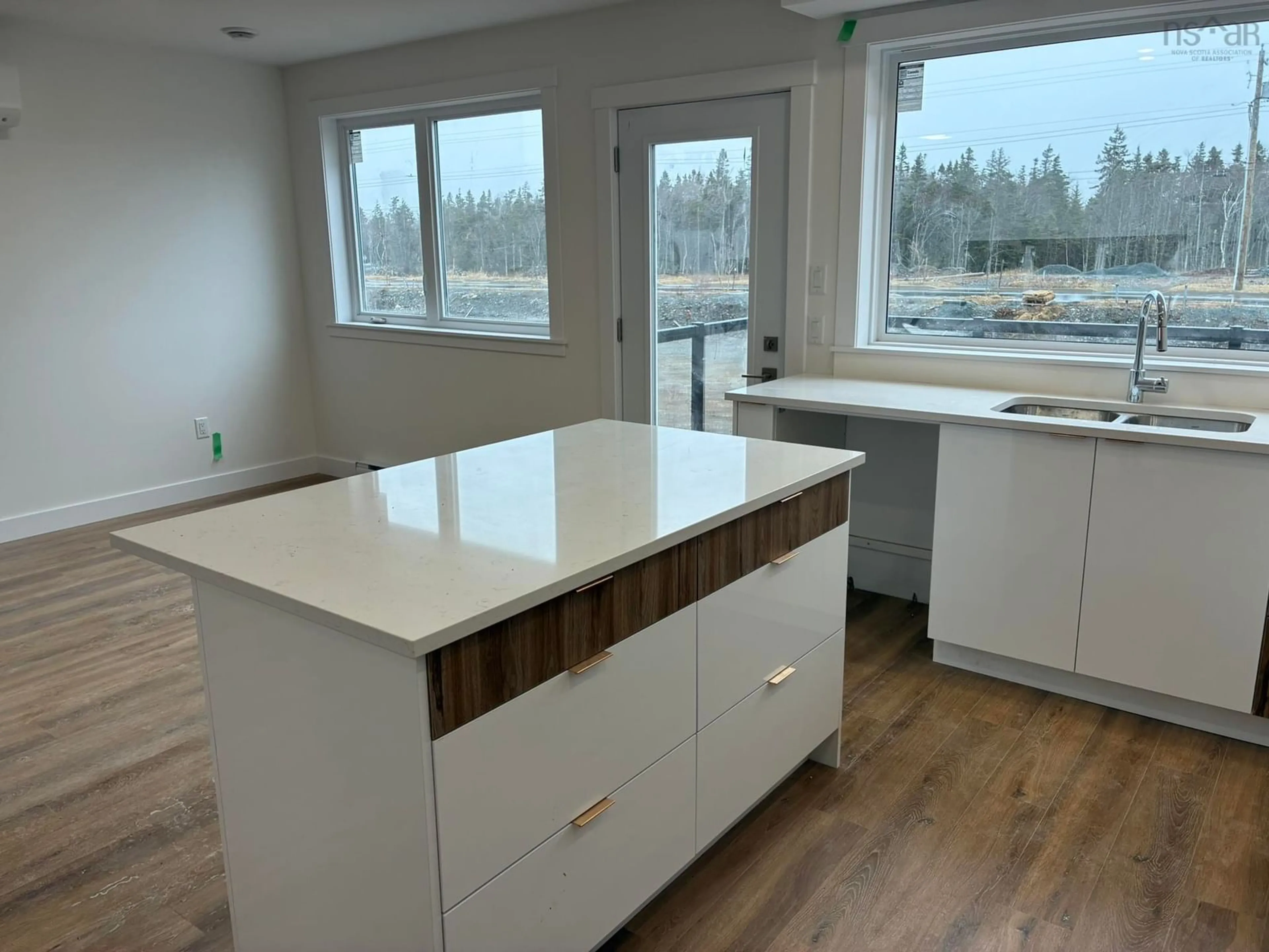 Open concept kitchen, wood/laminate floor for 44 Berm St, Spryfield Nova Scotia B3R 0H2